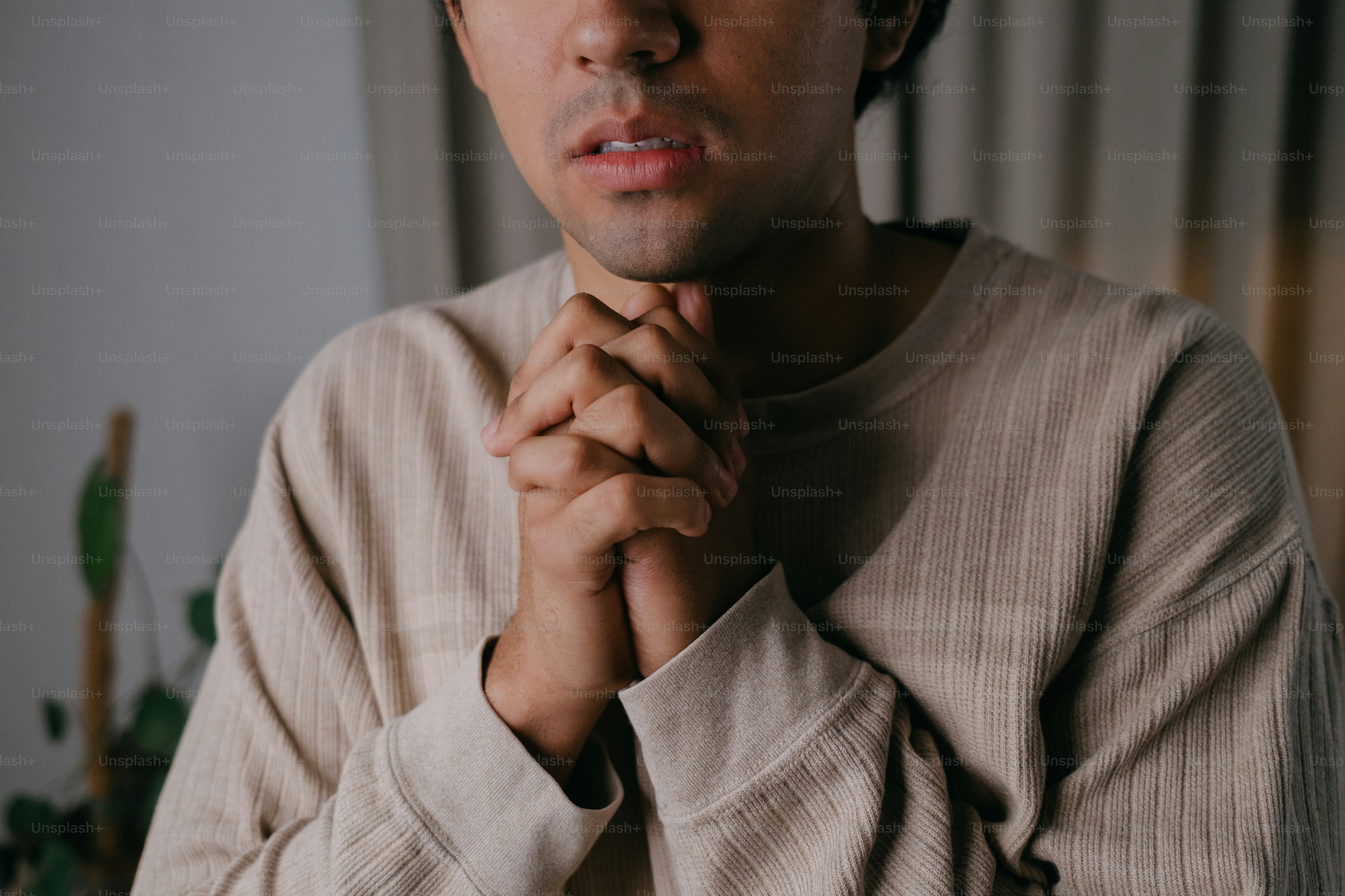 A man with his hands folded in prayer