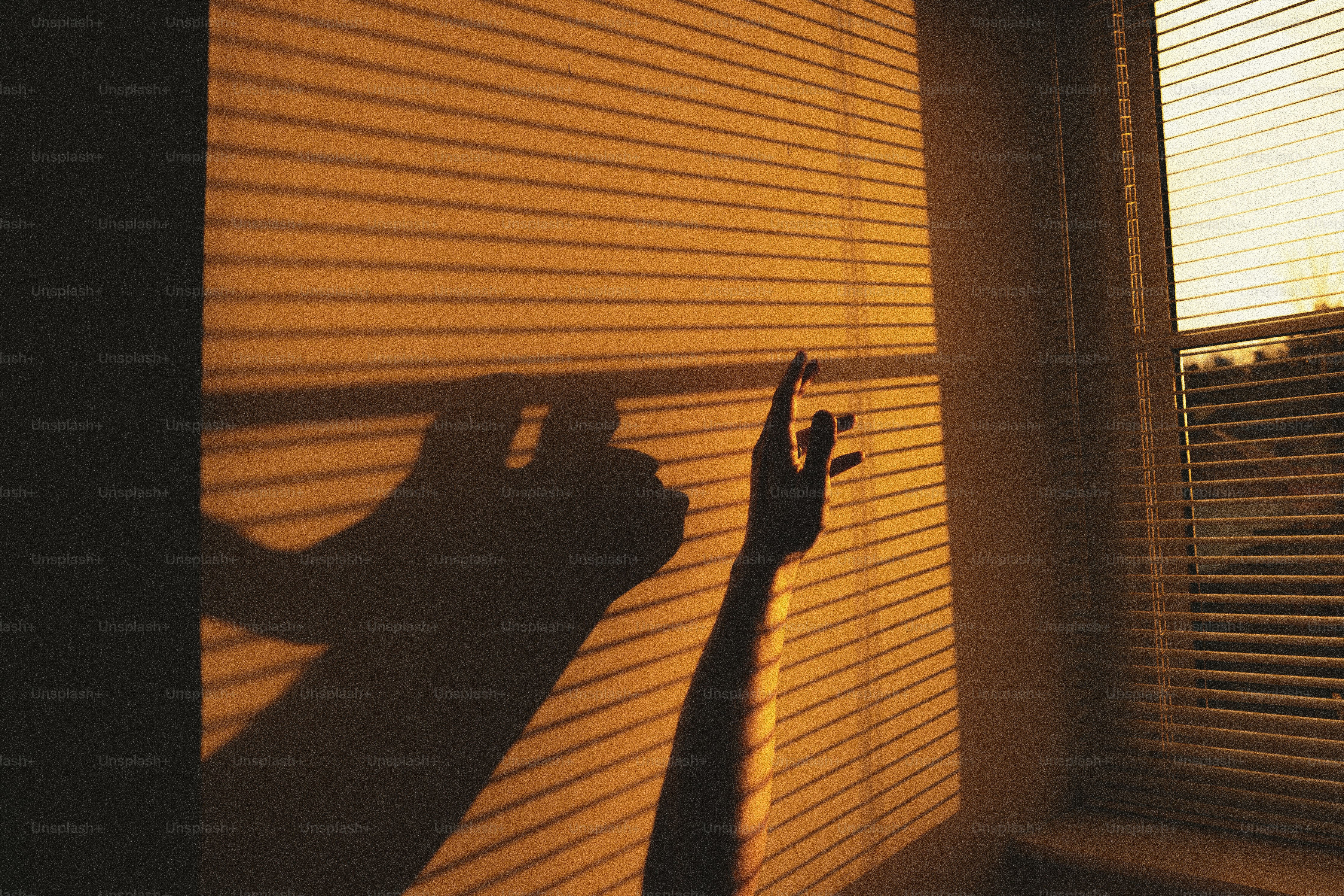 A shadow of a hand on a window sill