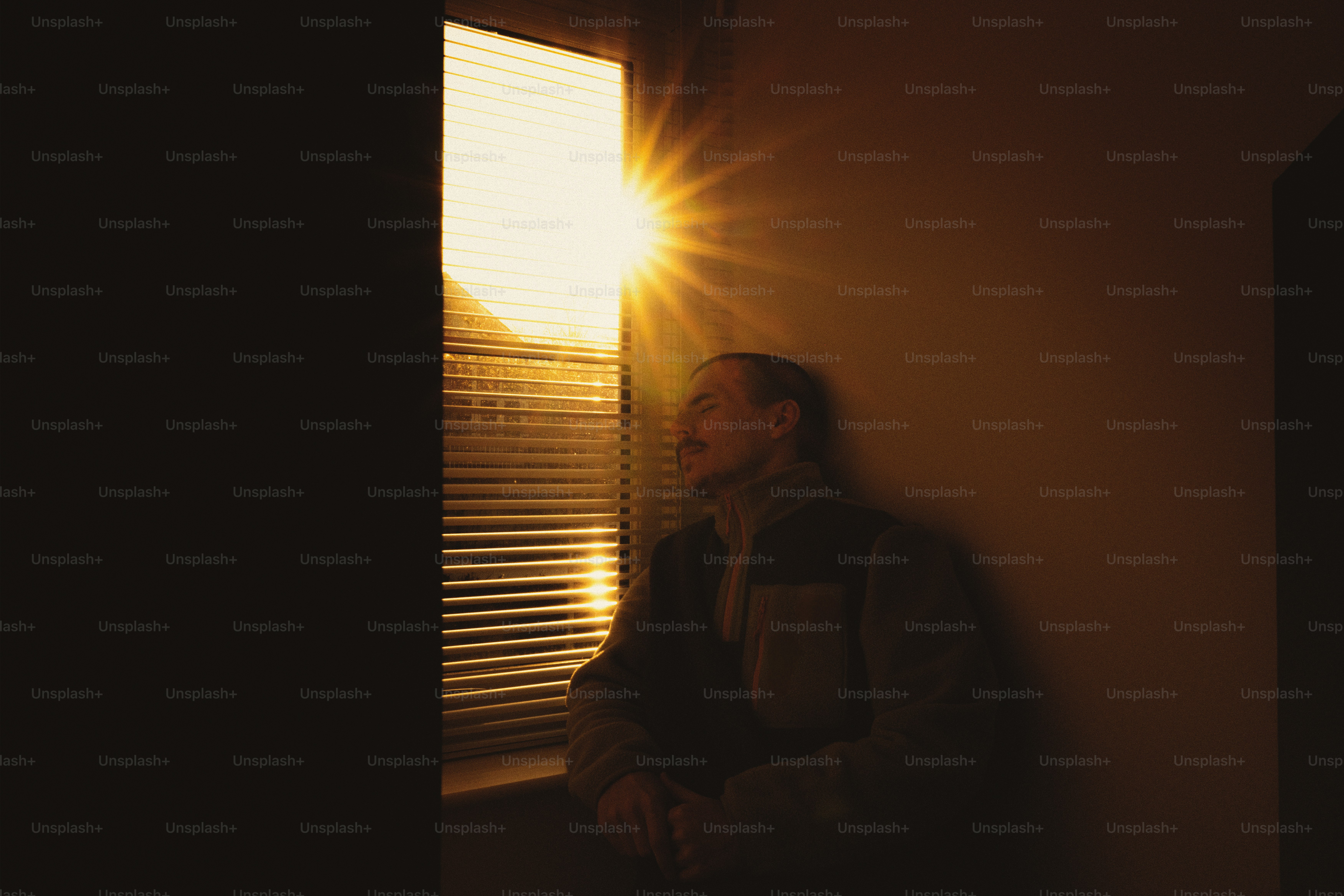 A man standing next to a window in a room
