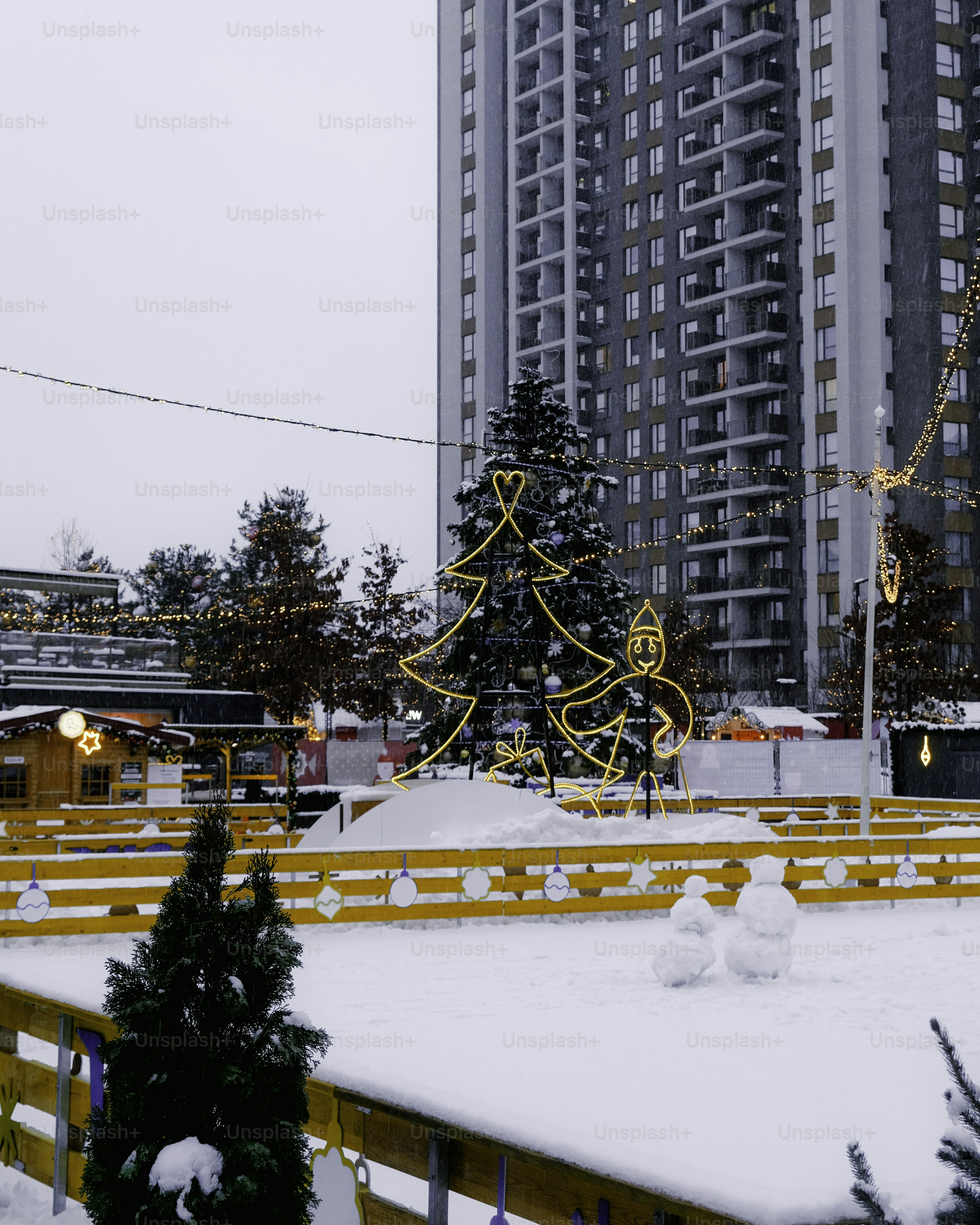 A large building with a christmas tree in the middle of it