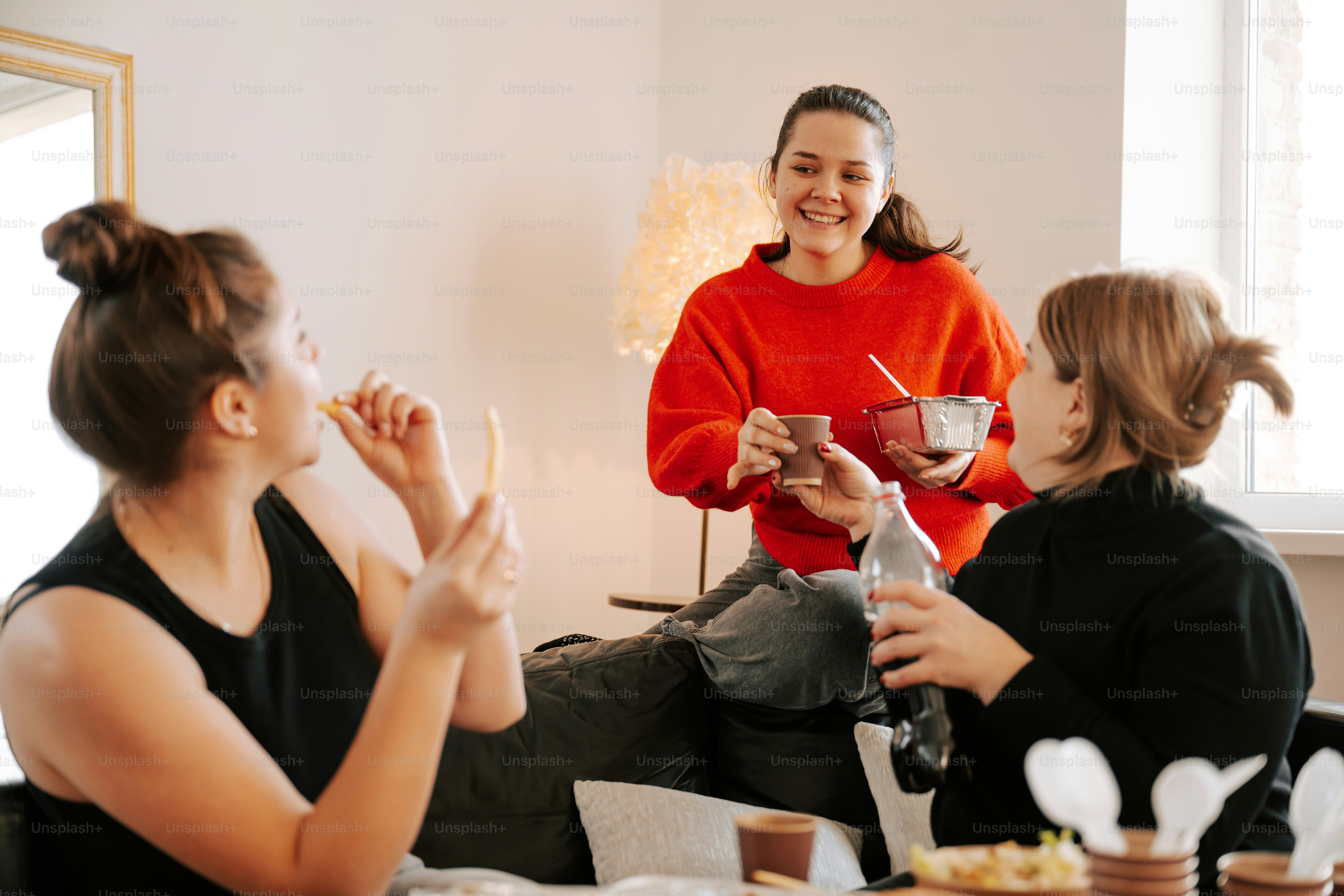 A group of women sitting around a table eating food