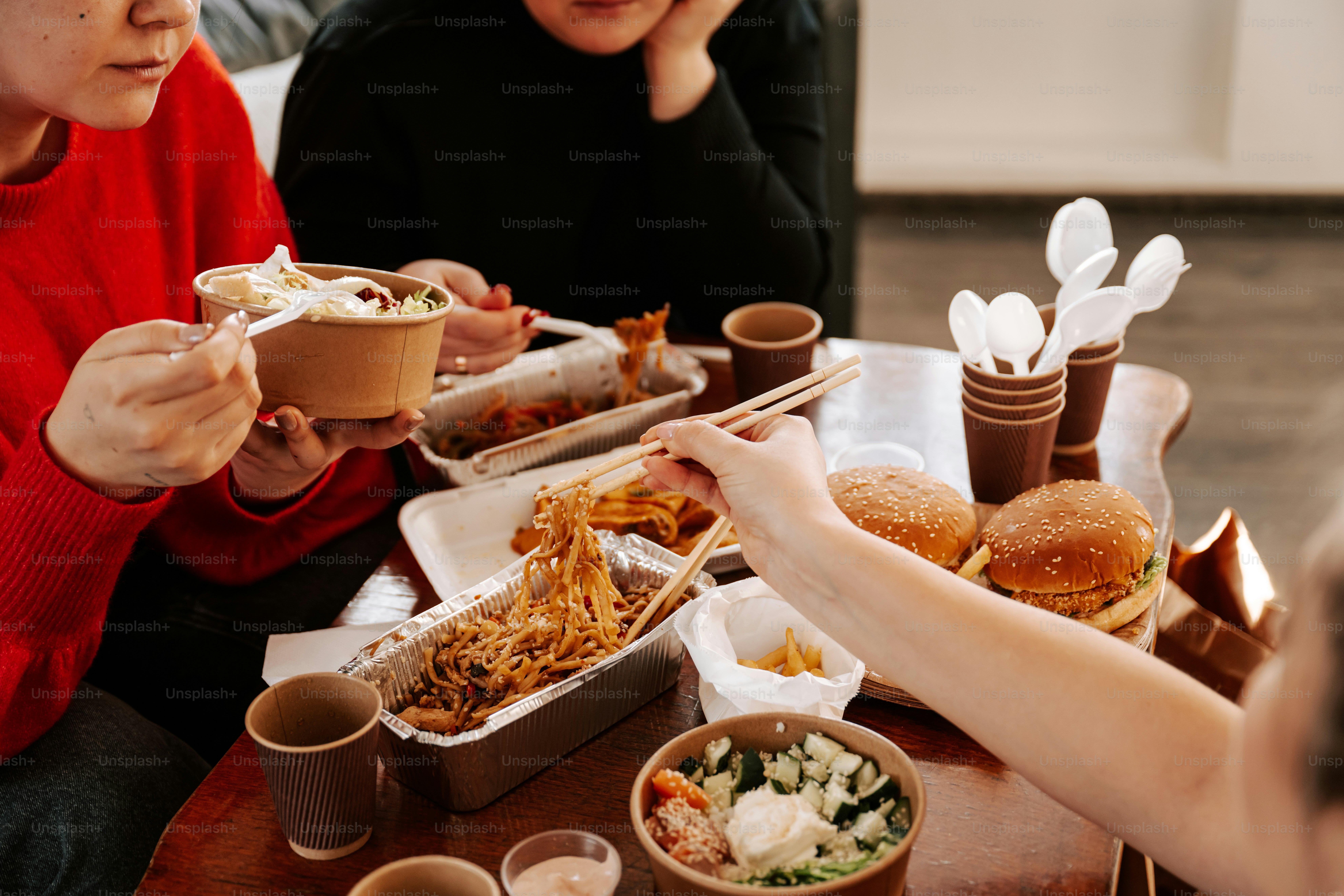 A group of people sitting around a table eating food