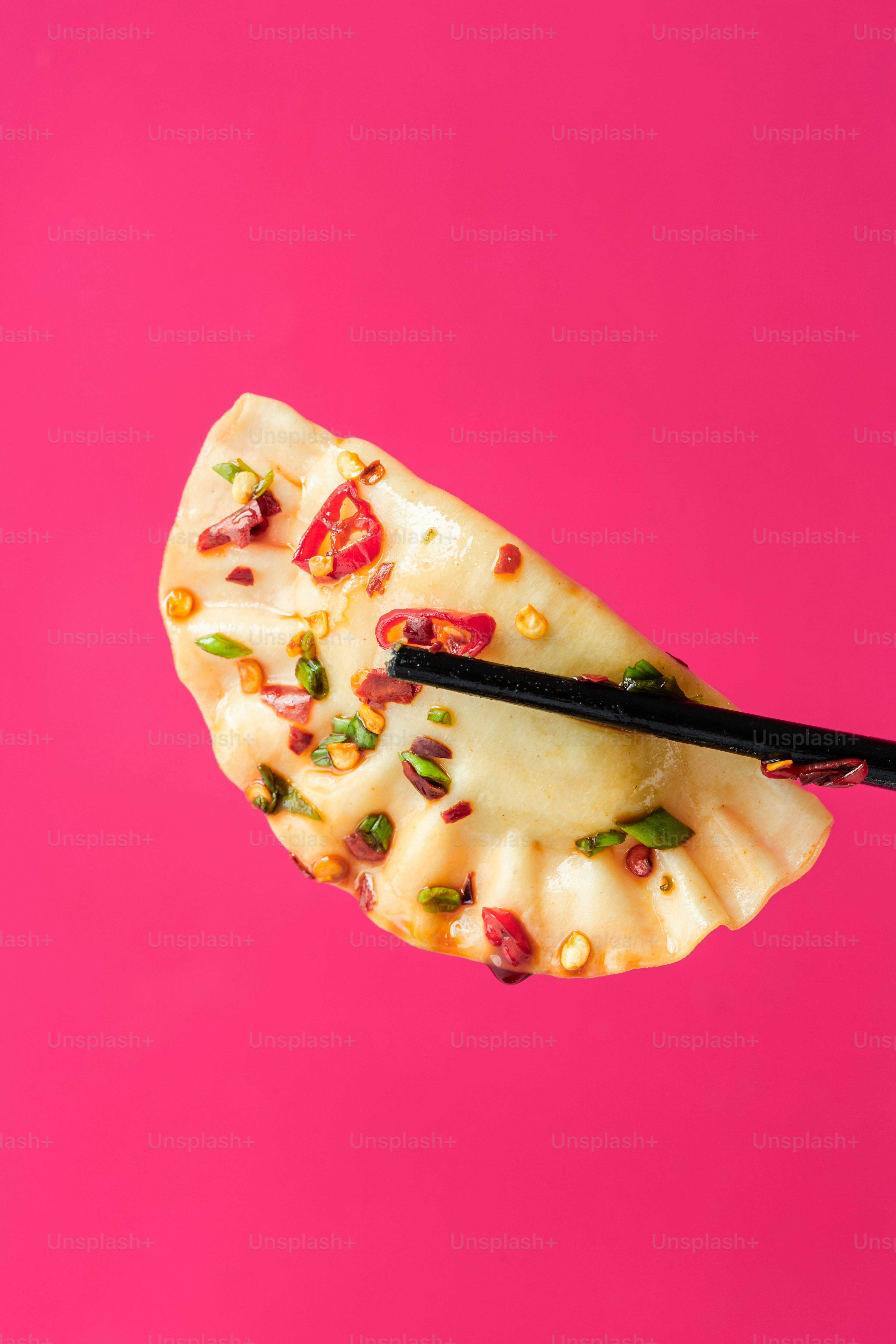 A pair of chopsticks sticking out of a piece of food