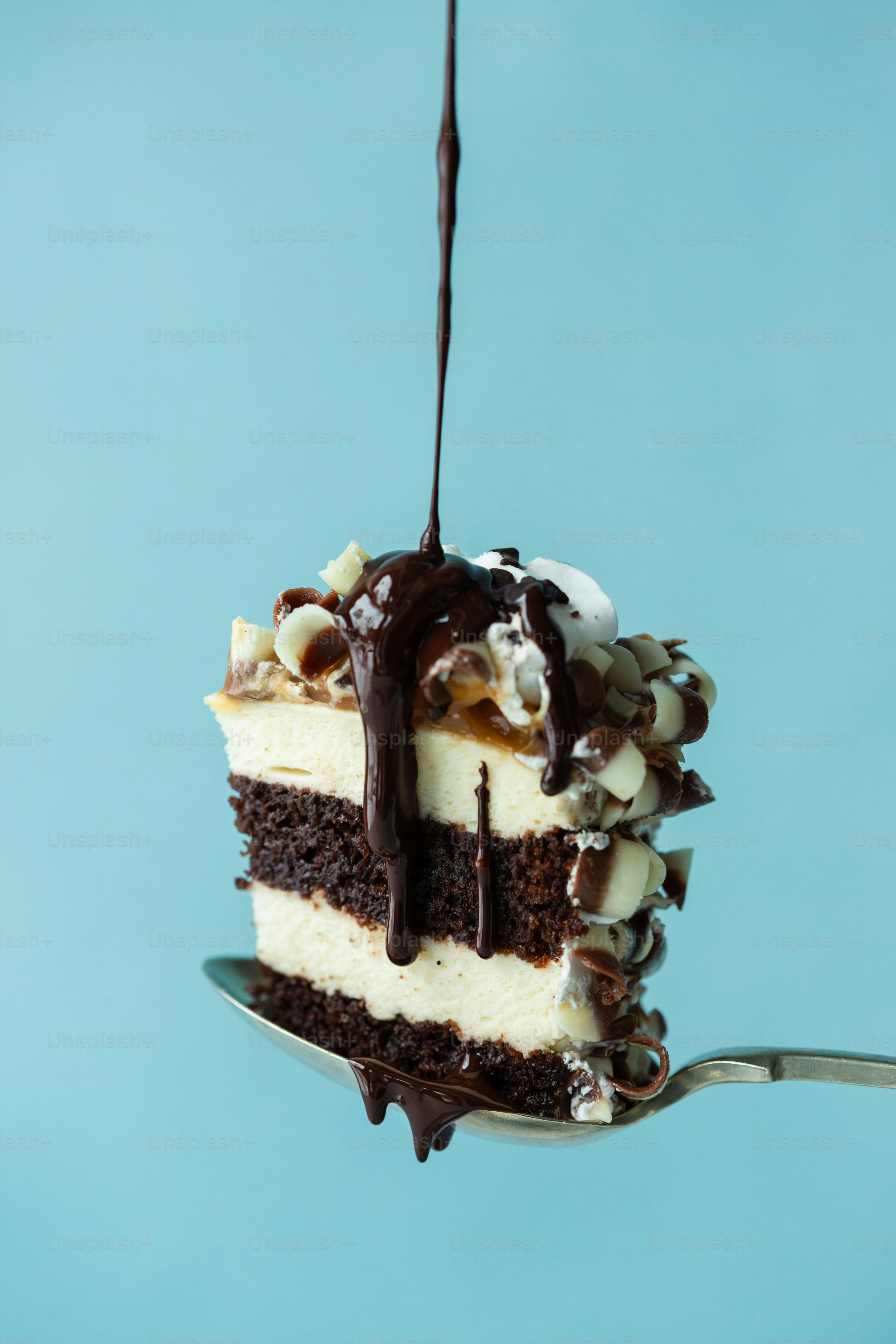 A piece of cake is being lifted by a fork