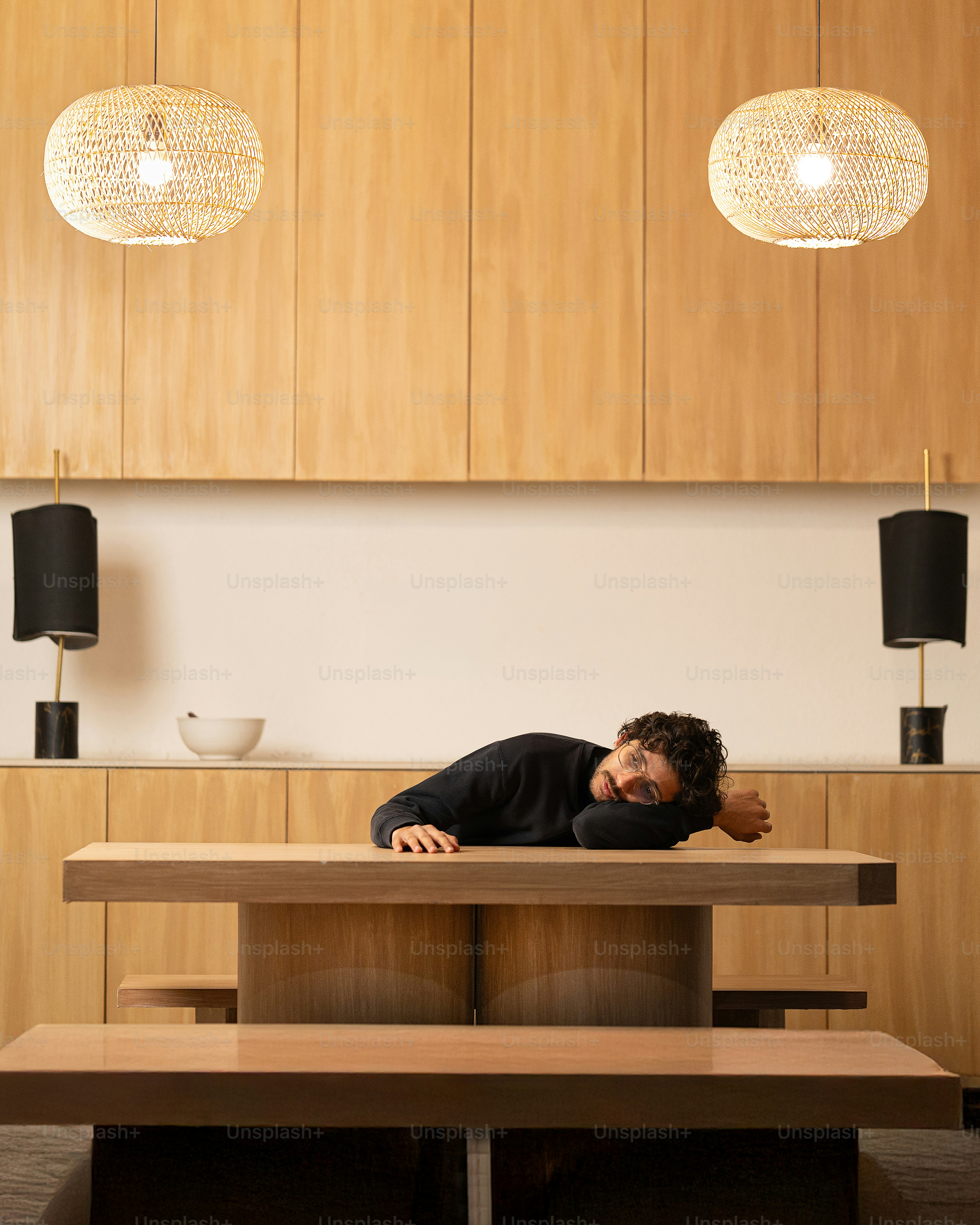 A man laying on top of a wooden table photo – Sad Image on Unsplash