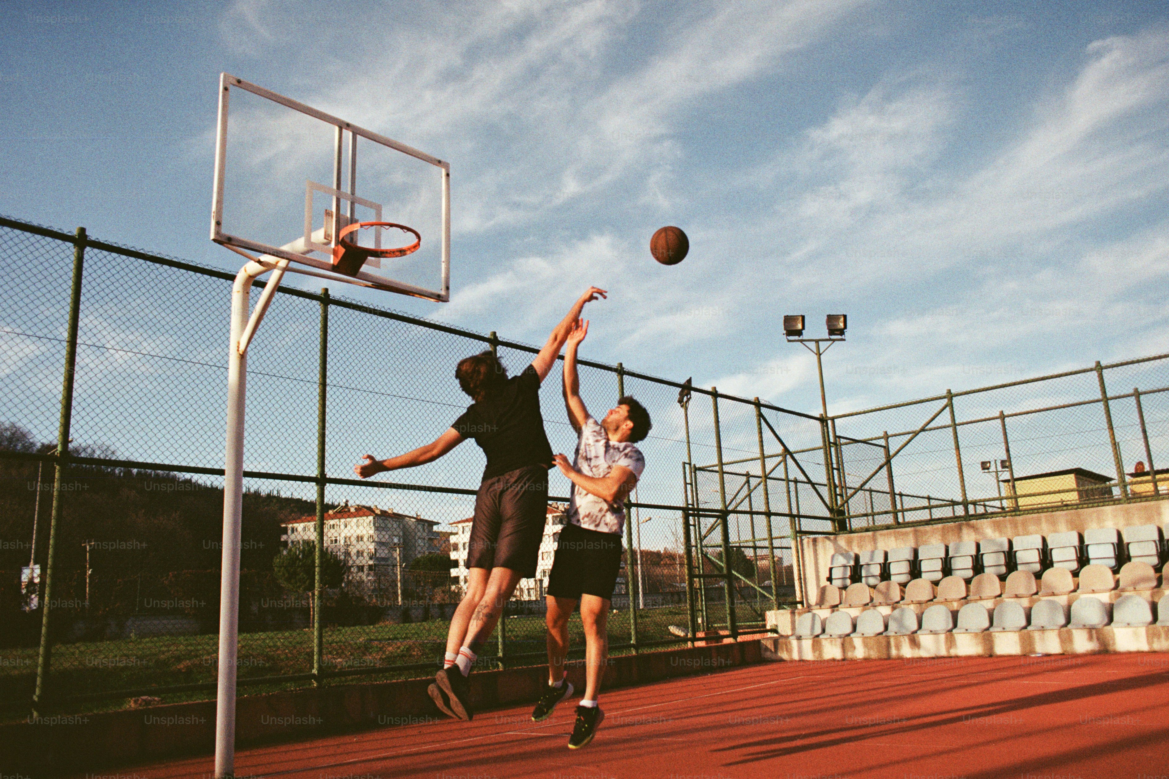 A couple of men playing a game of basketball