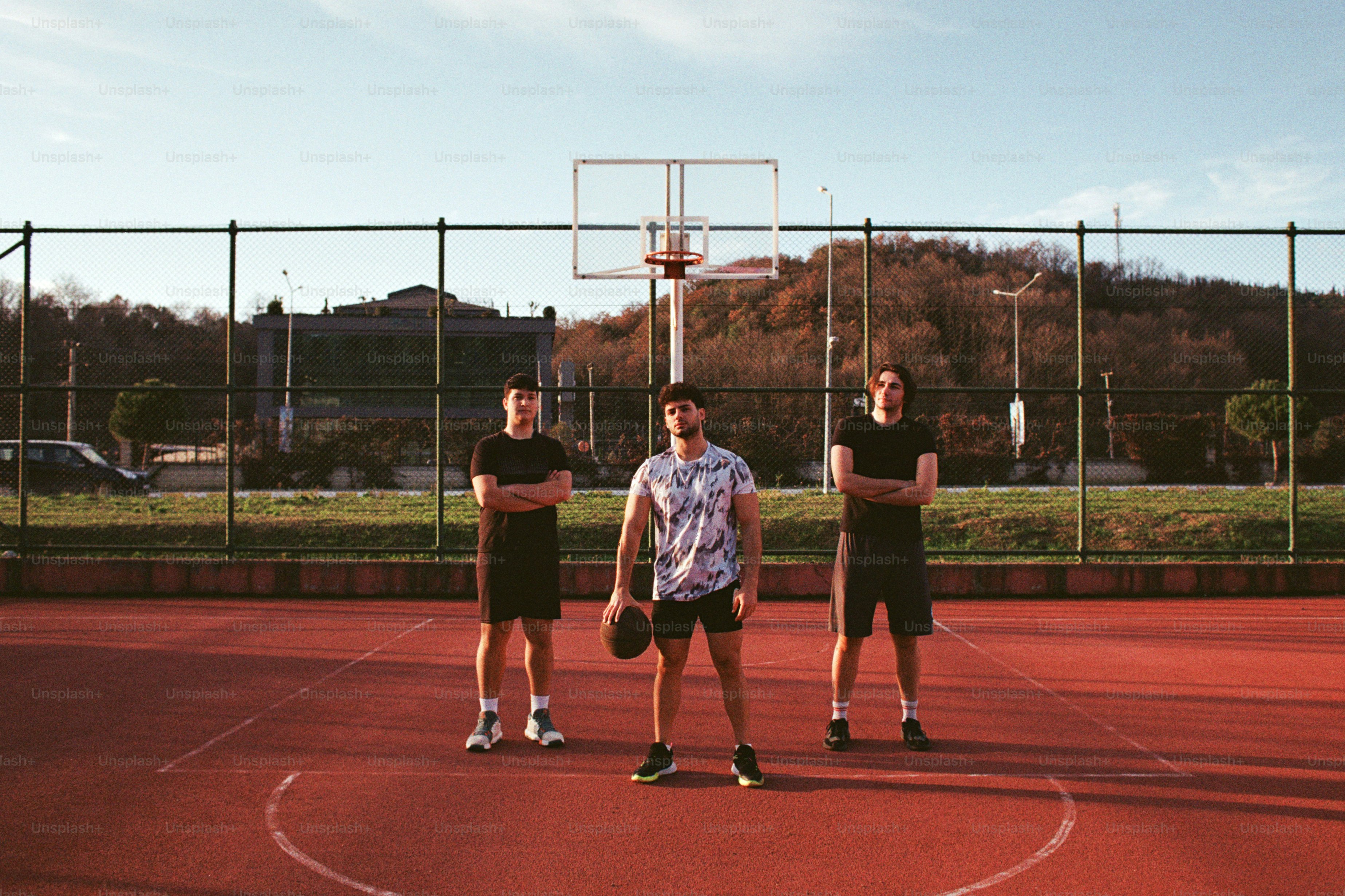 A group of young men standing on top of a tennis court