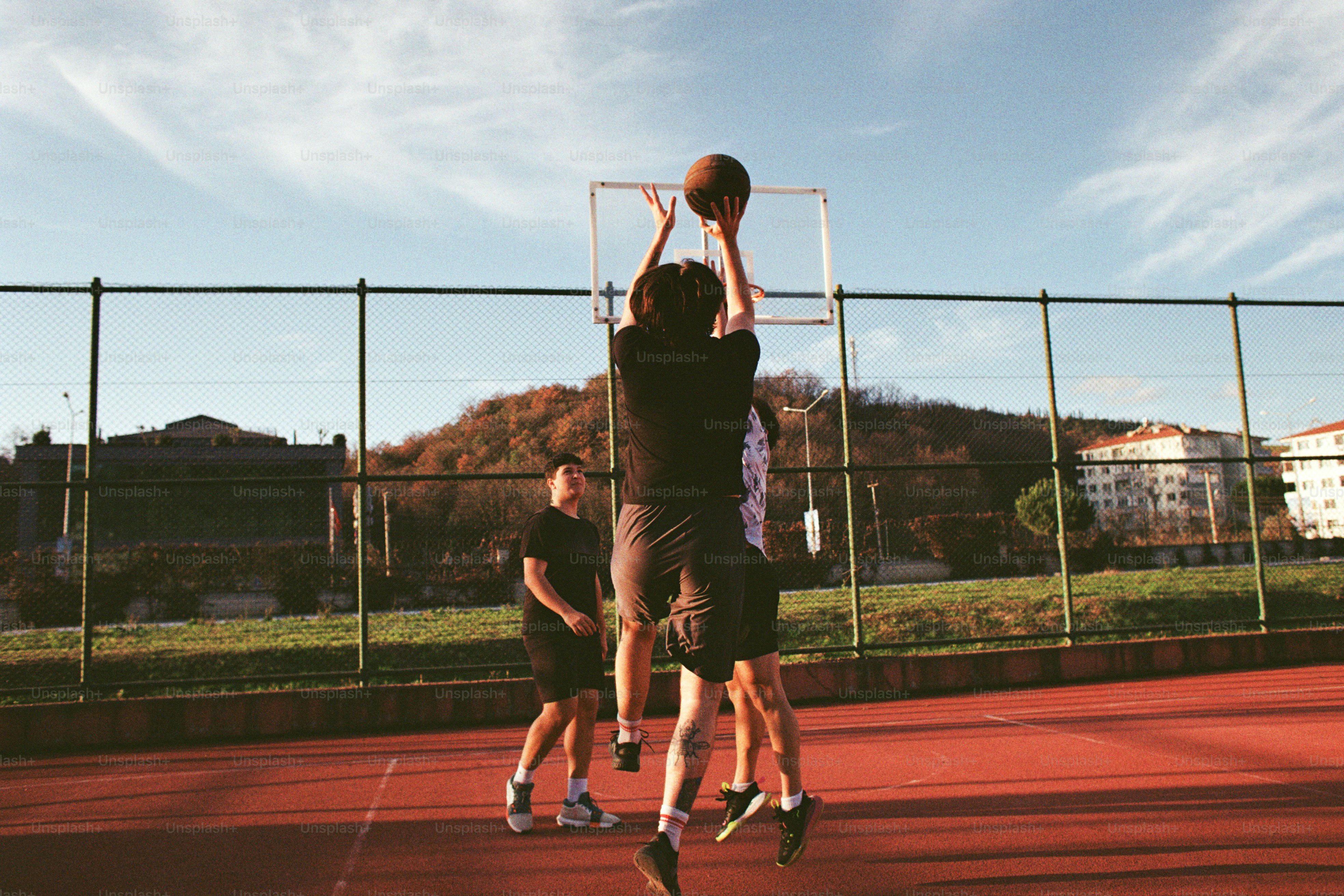 A group of young men playing a game of basketball