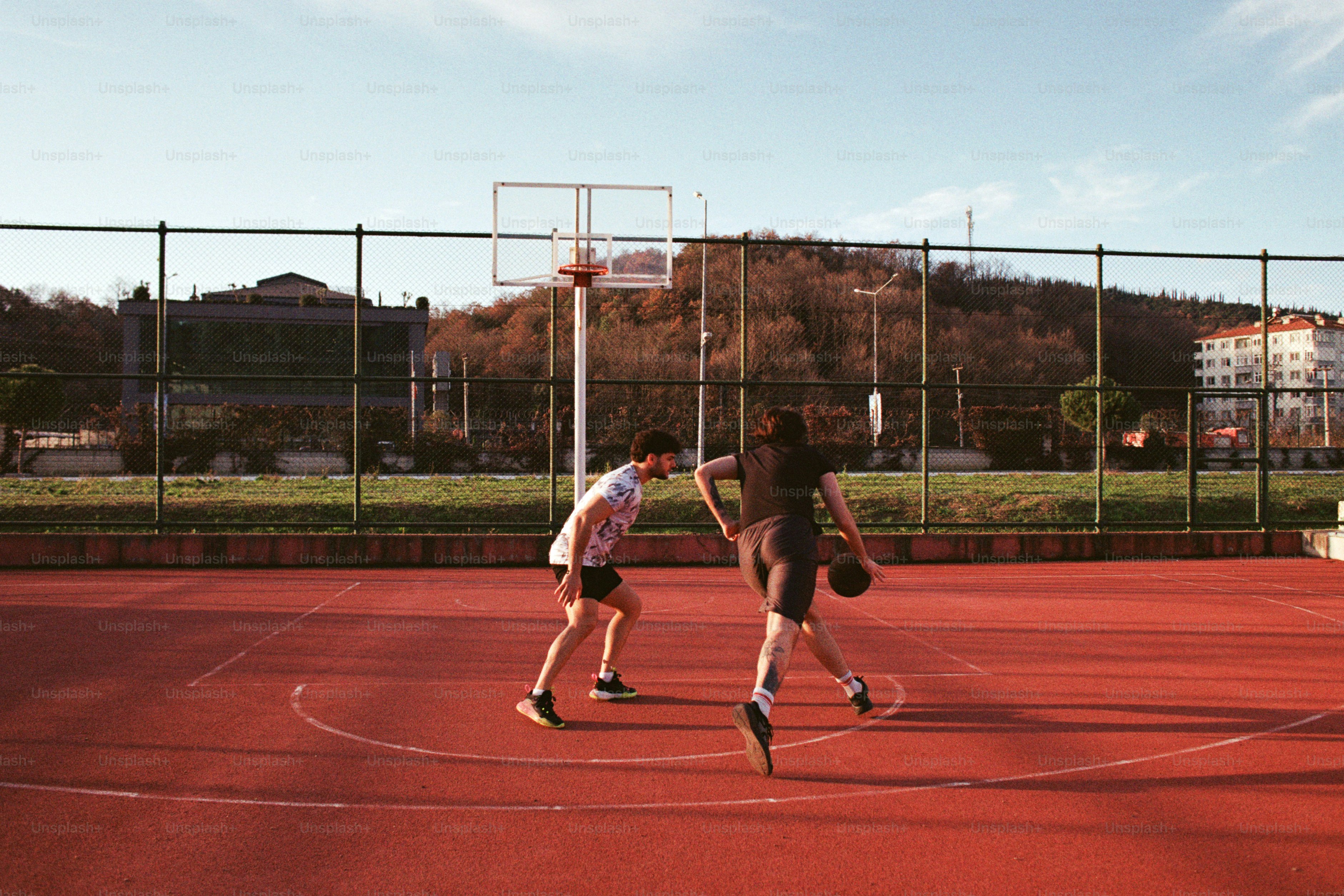 A couple of people standing on a basketball court