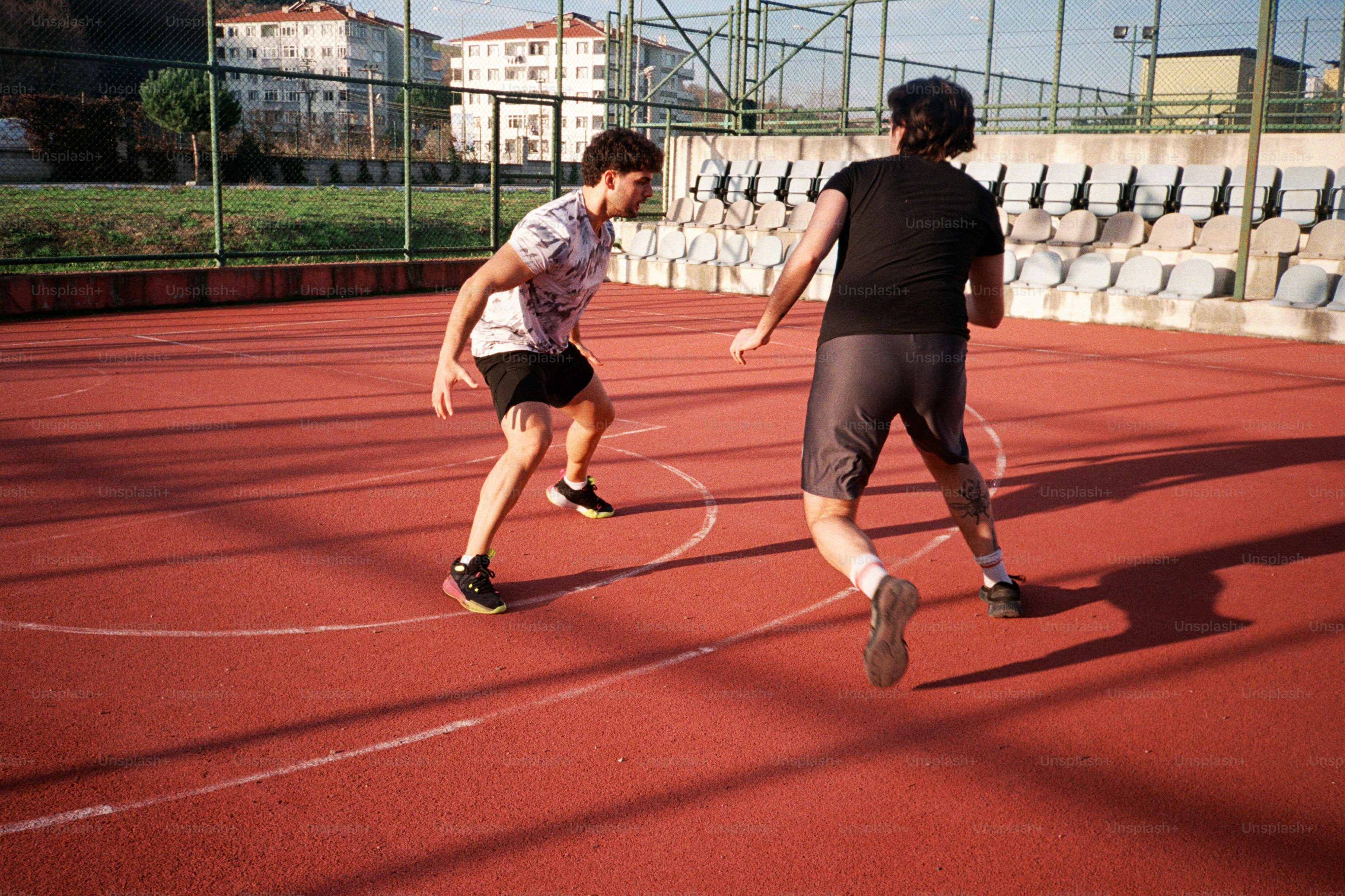 A couple of people on a court with a tennis racket