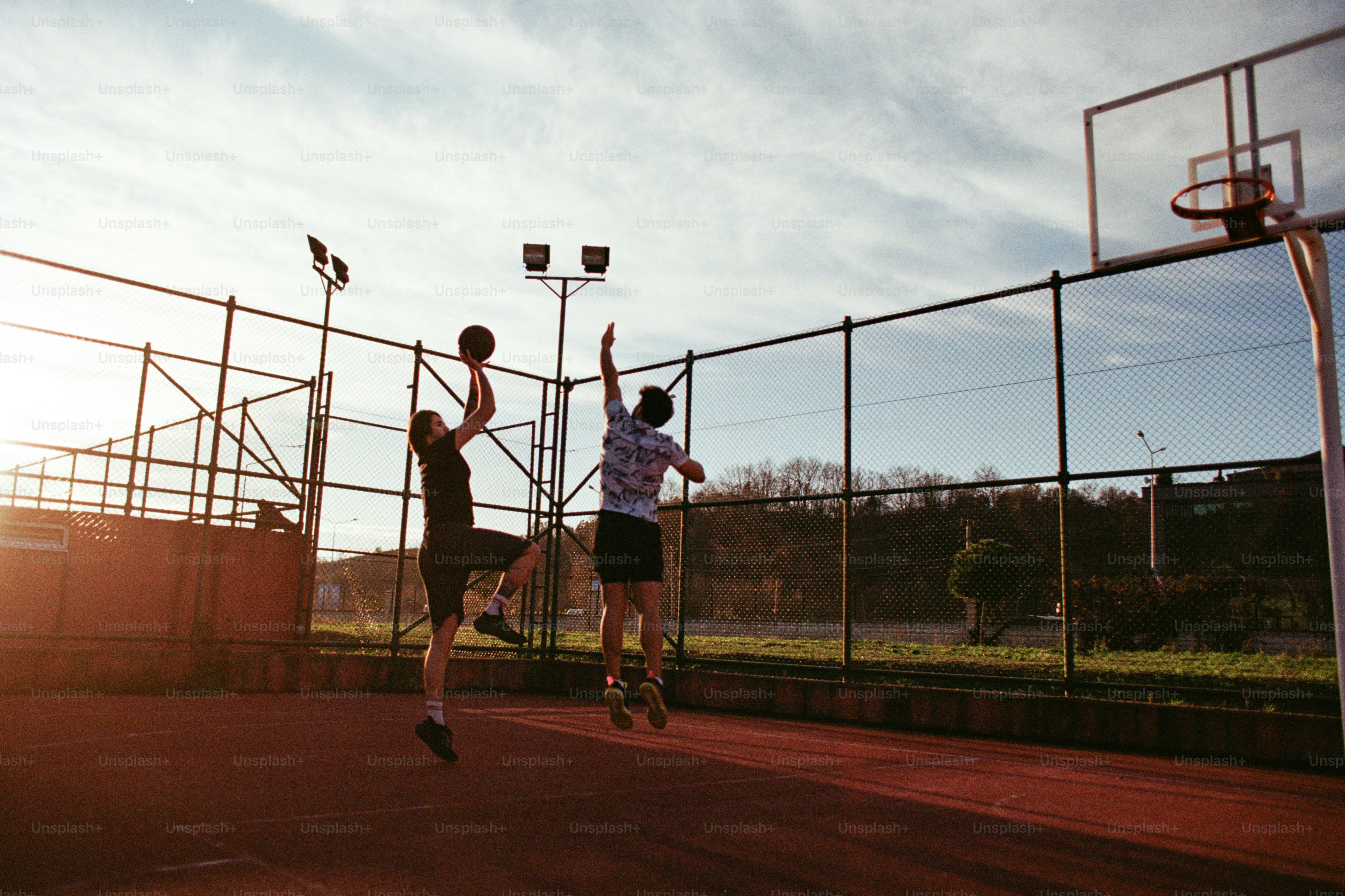 A couple of men playing a game of basketball