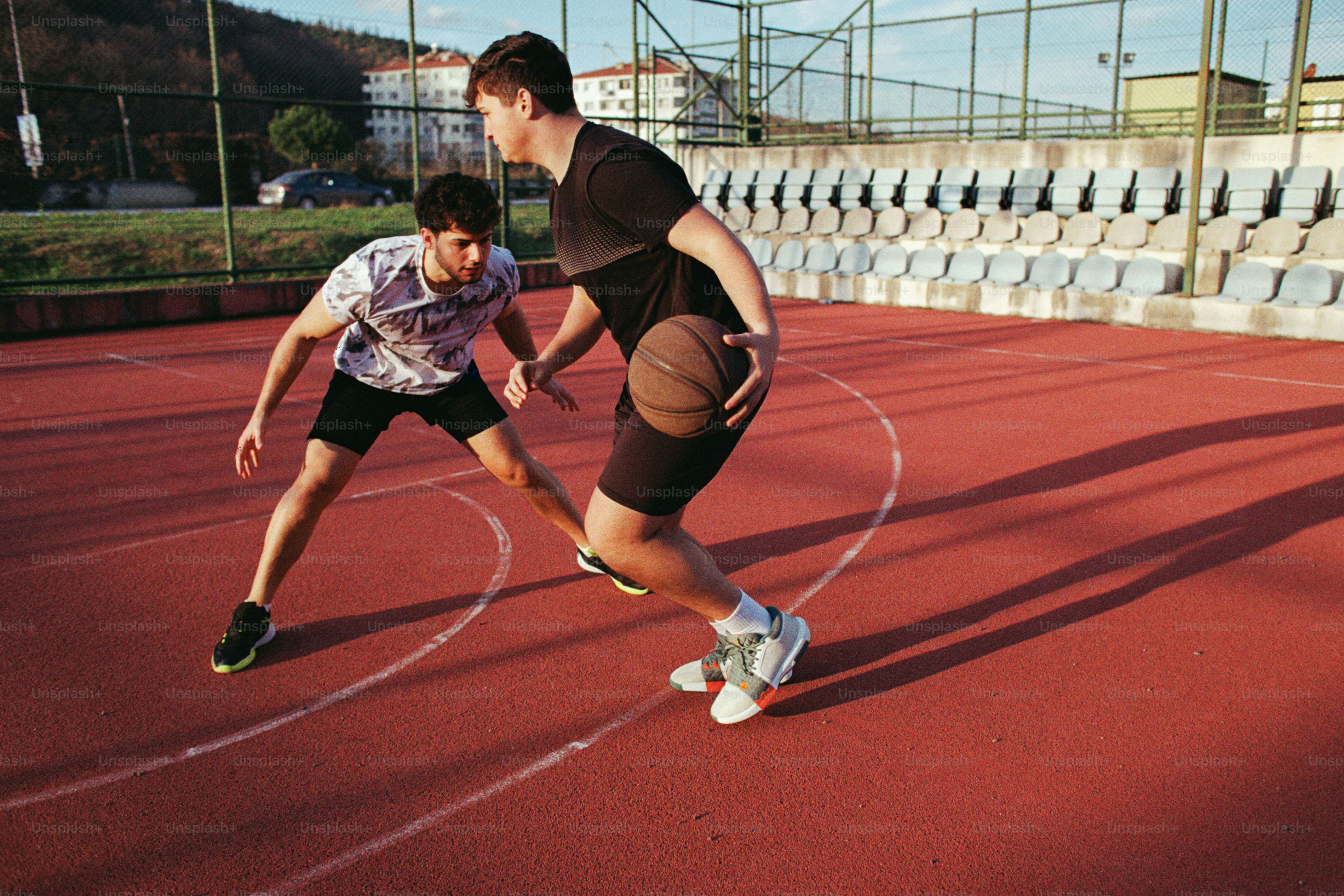 A couple of men standing on top of a tennis court
