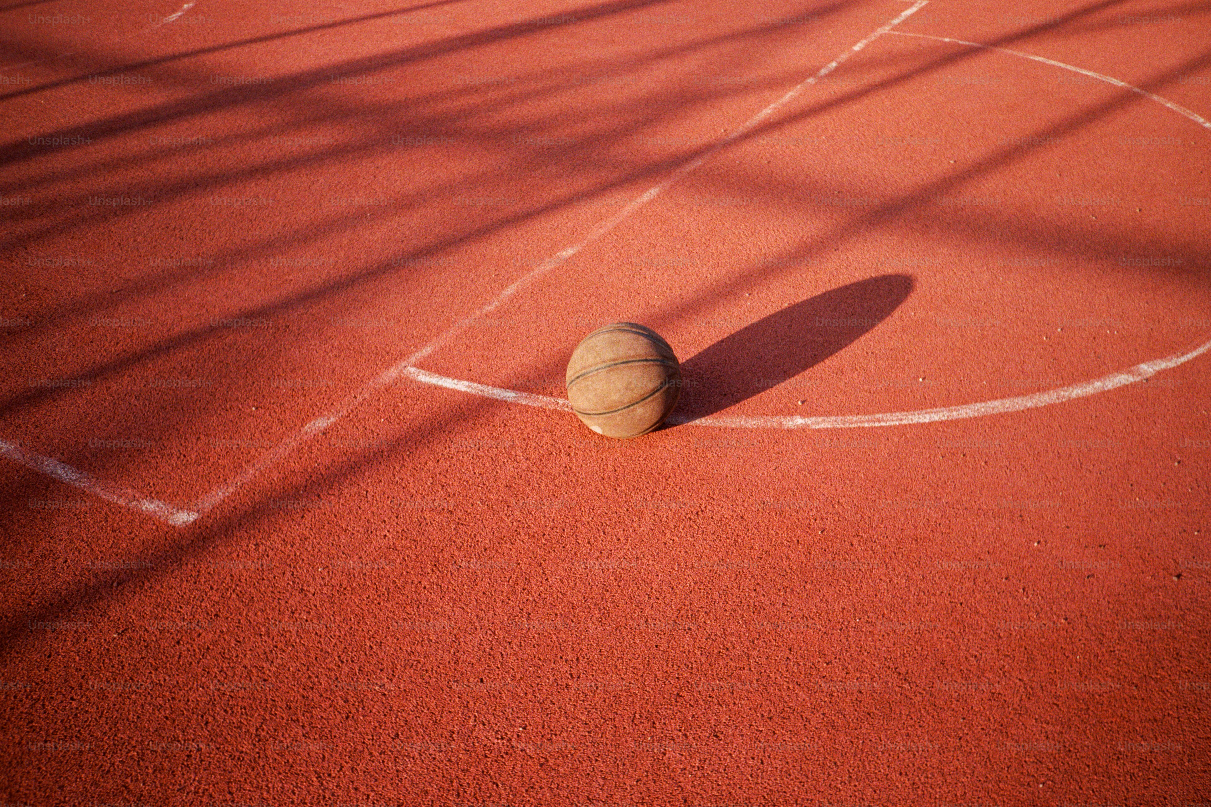 A tennis court with a tennis ball on it