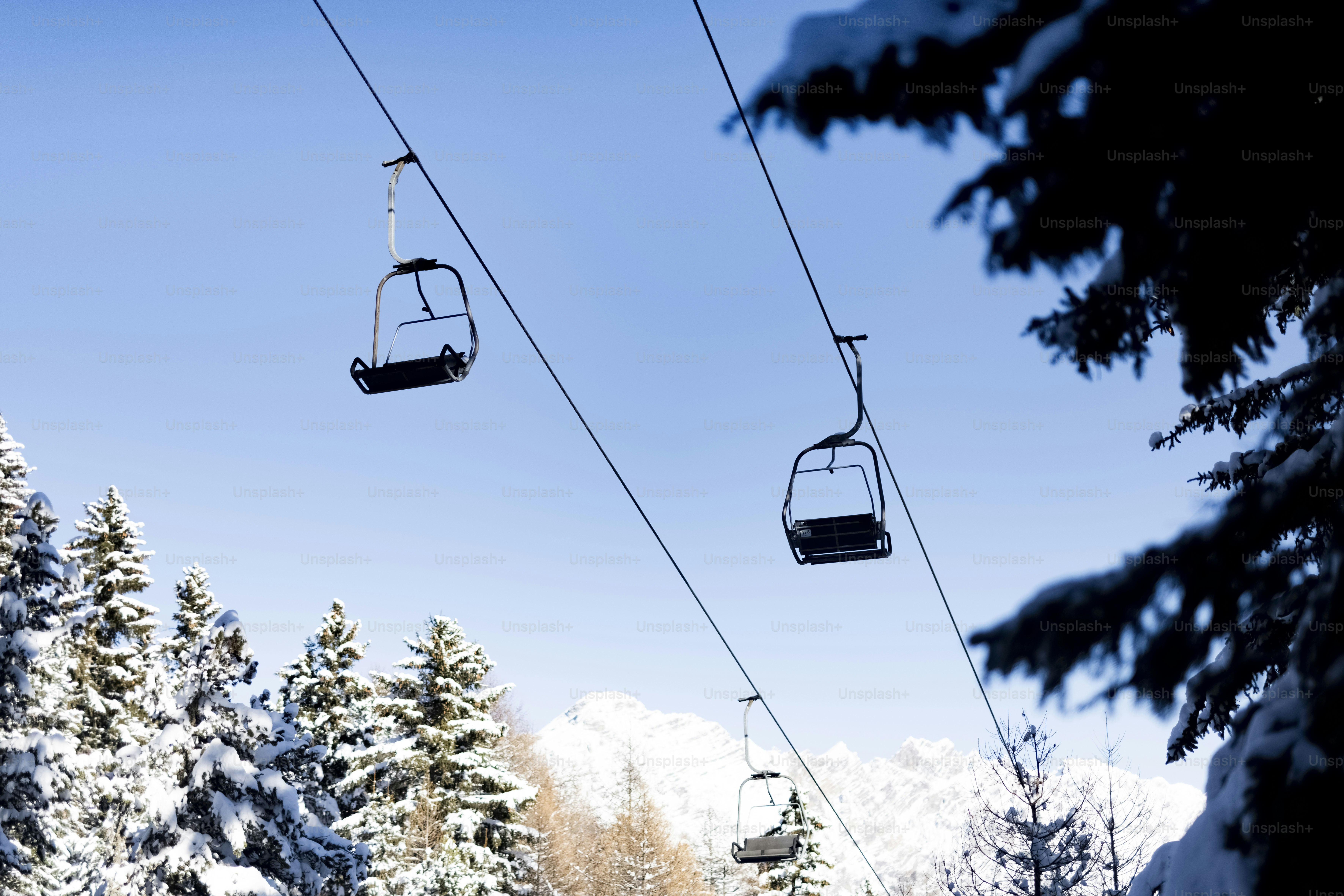 A ski lift going up a snowy mountain
