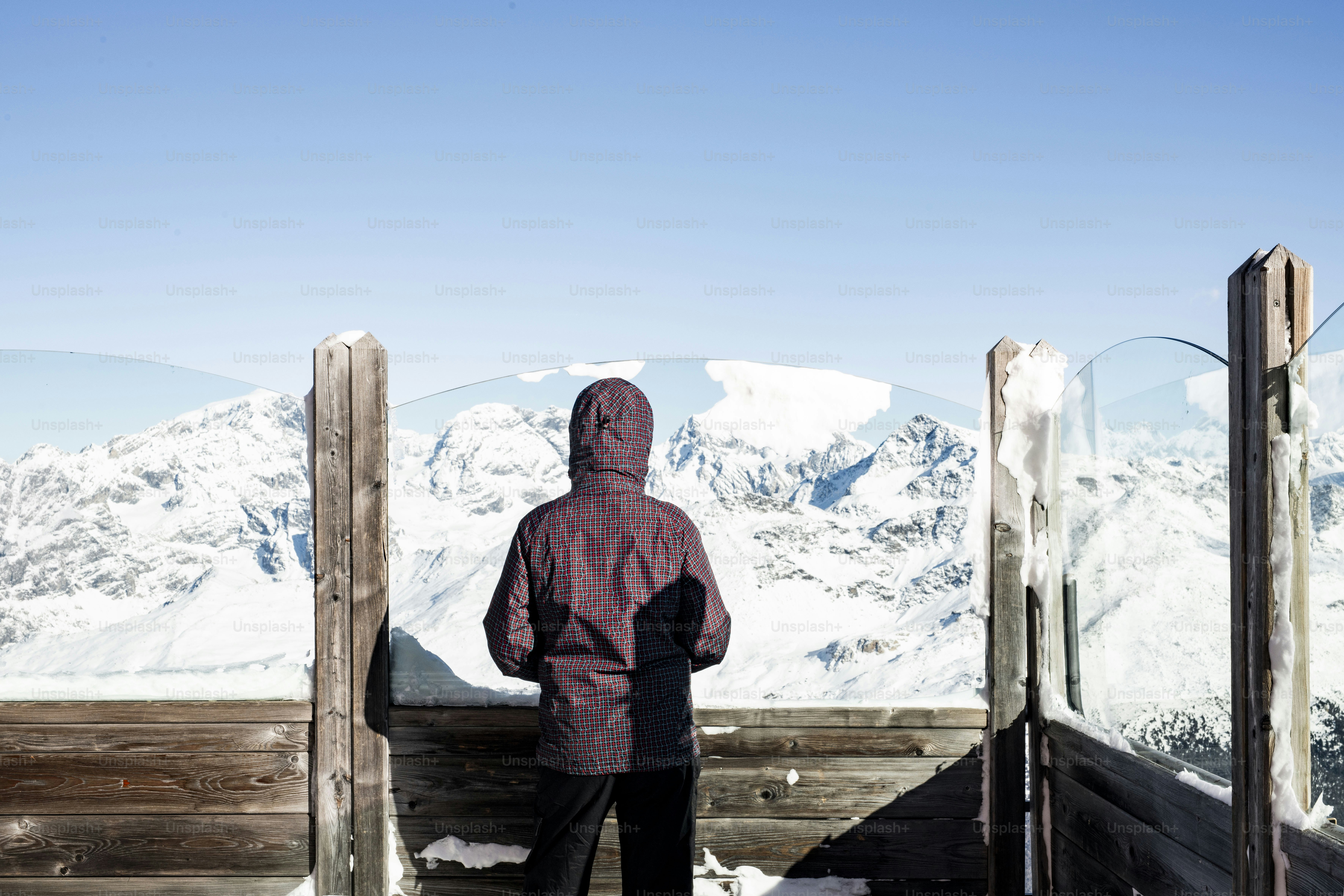 A man standing on top of a snow covered slope