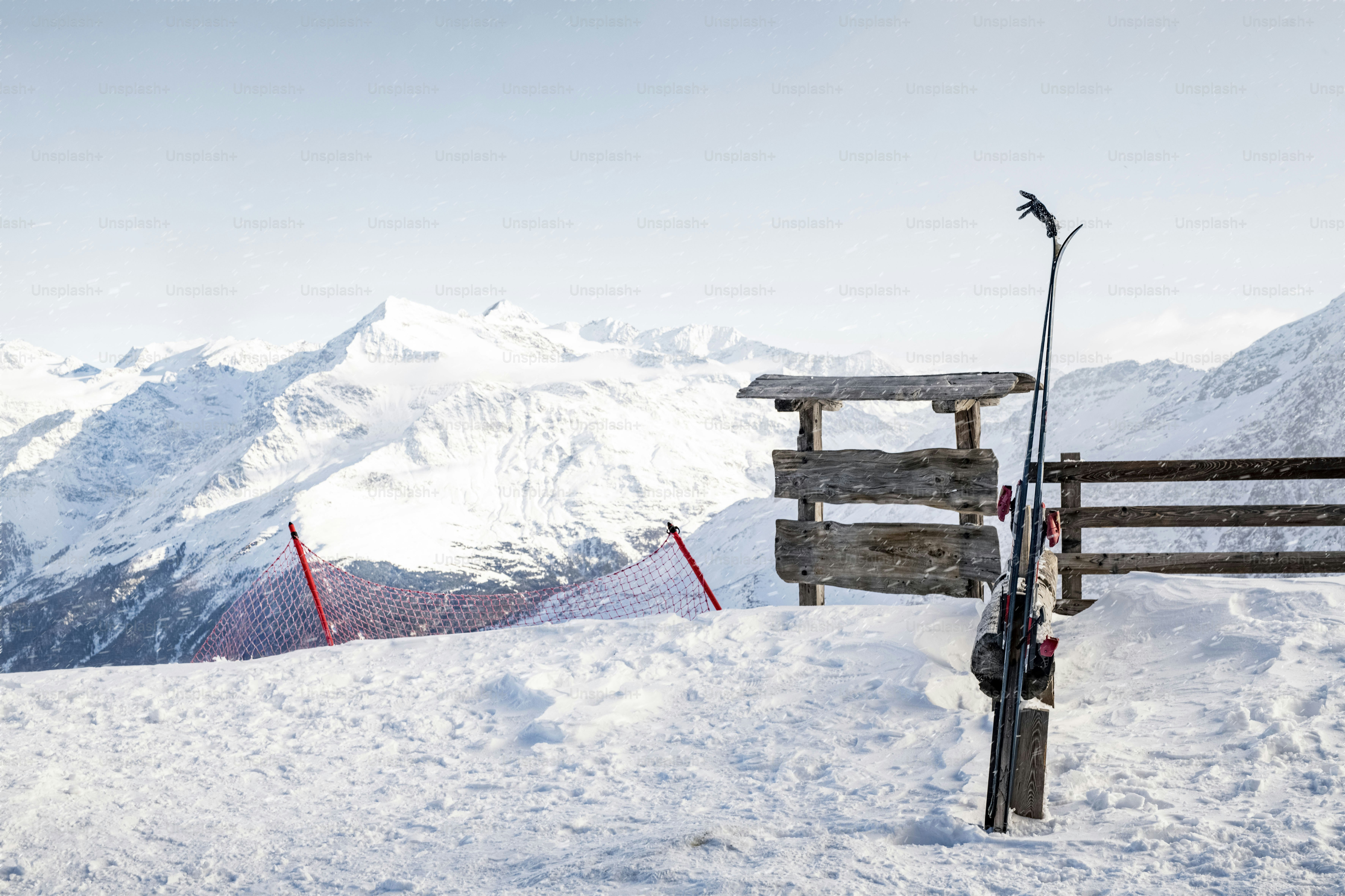 A person standing on top of a snow covered slope