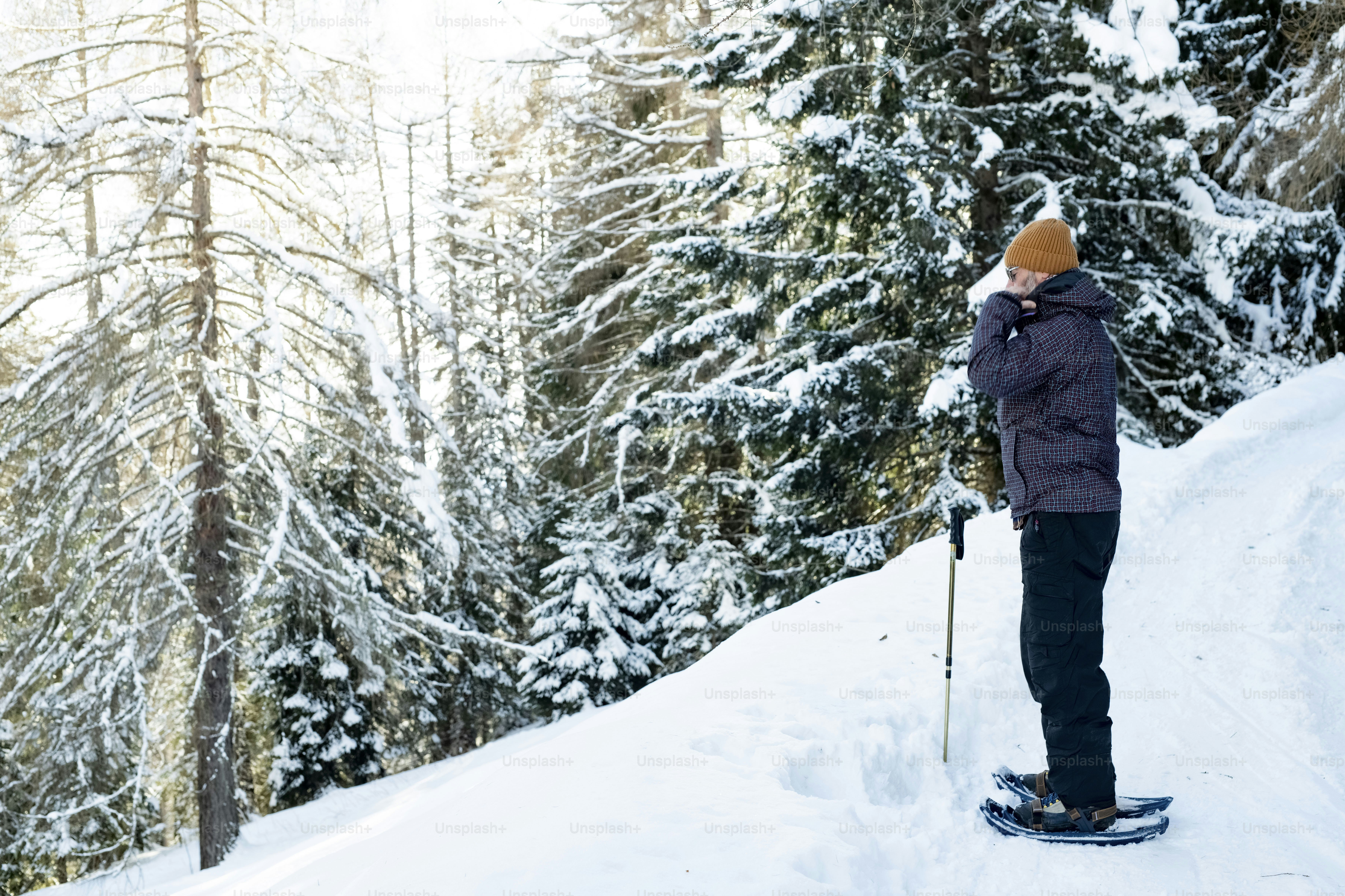 A man riding skis down a snow covered slope