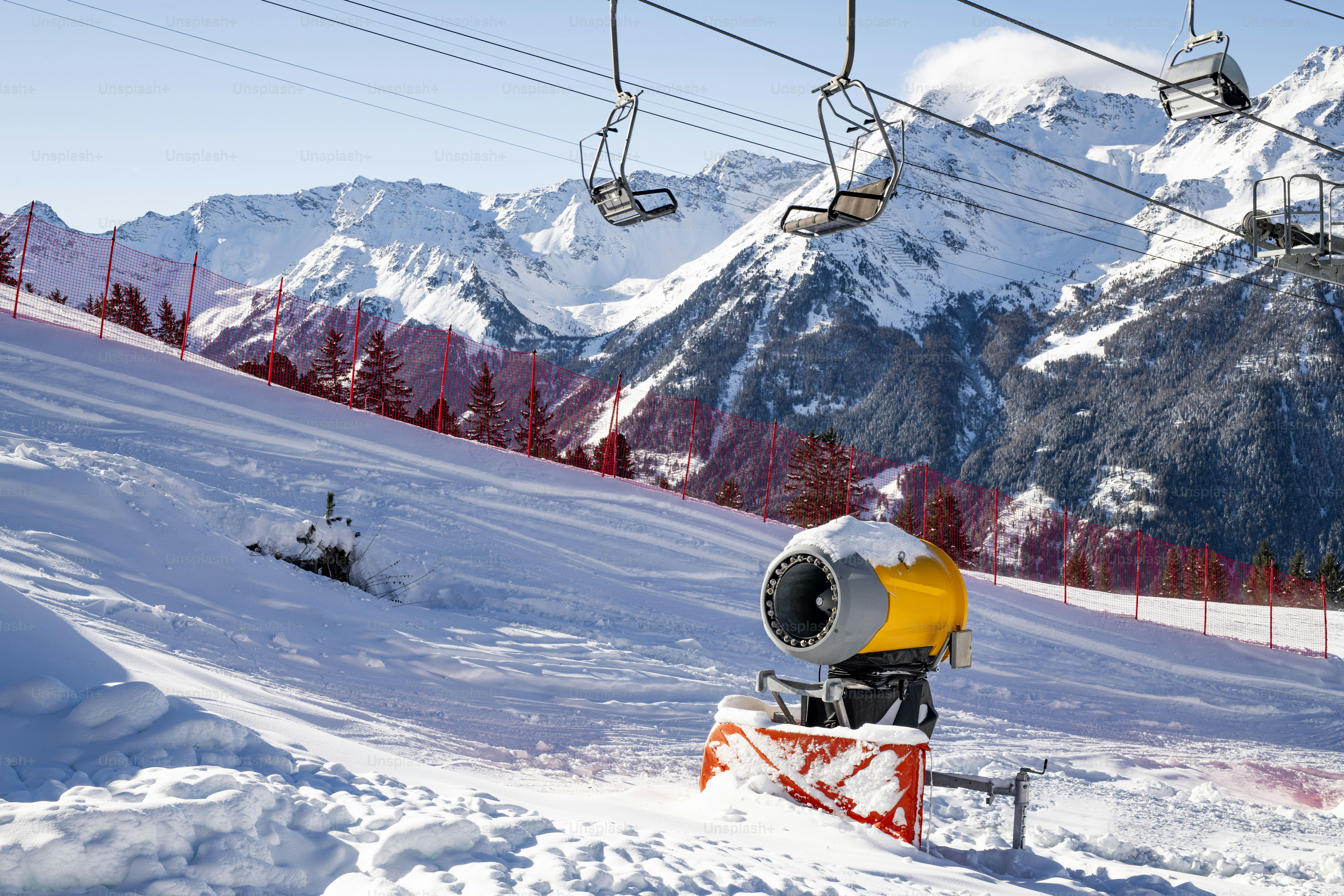 A man riding a snowboard down a snow covered slope