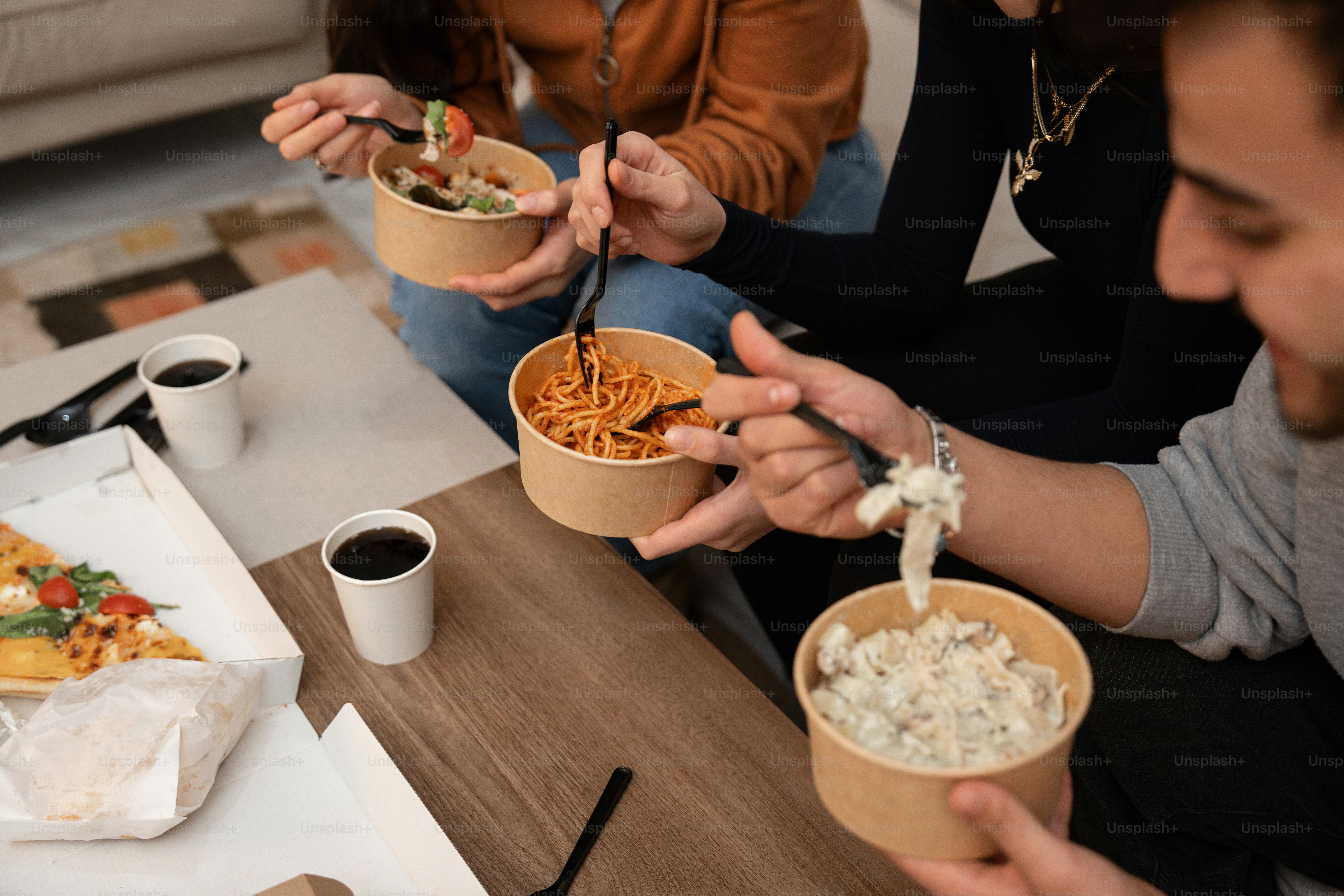 A group of people sitting around a table eating food
