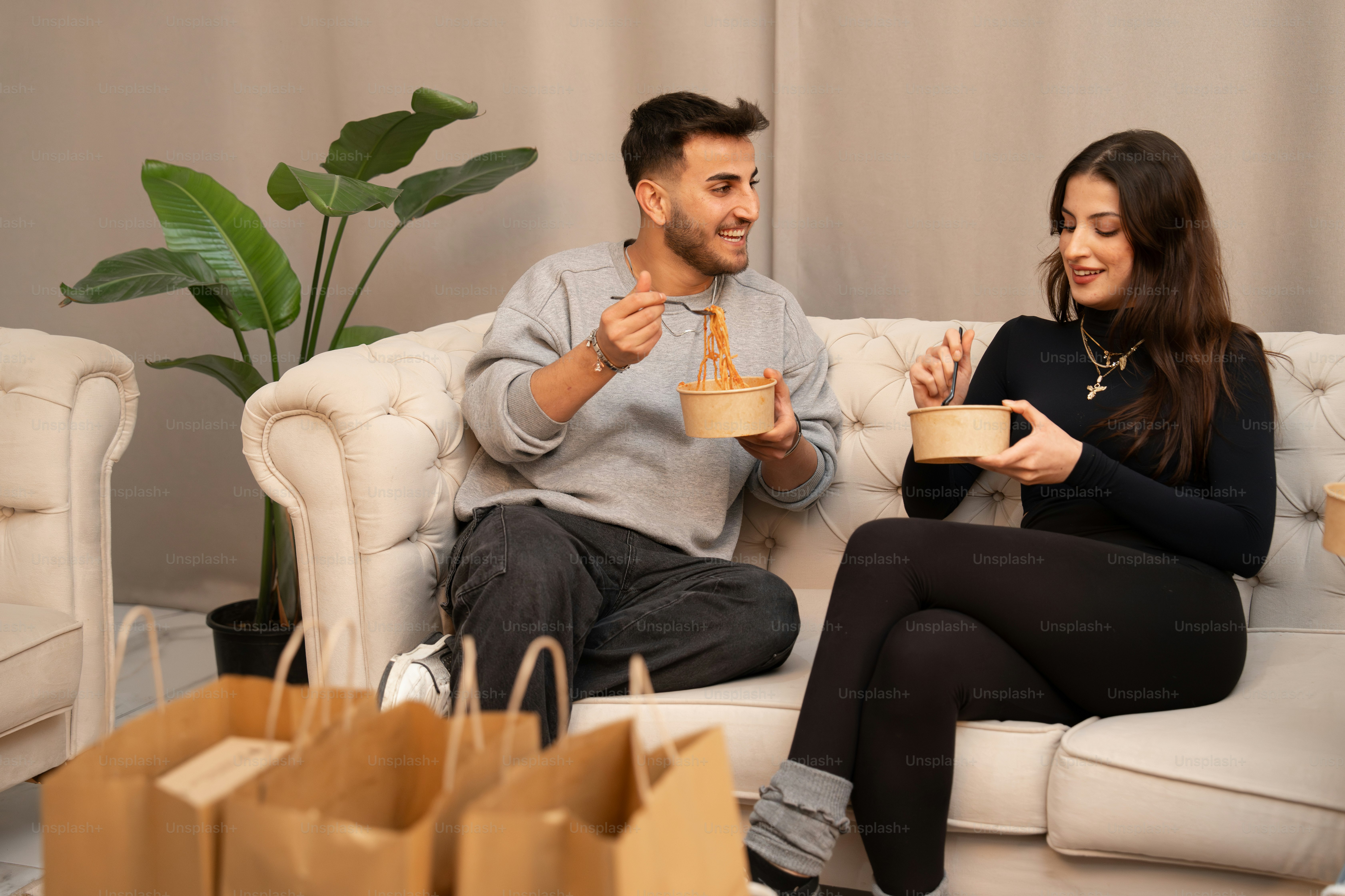 소파에 앉아 커피잔을 들고 있는 남녀
