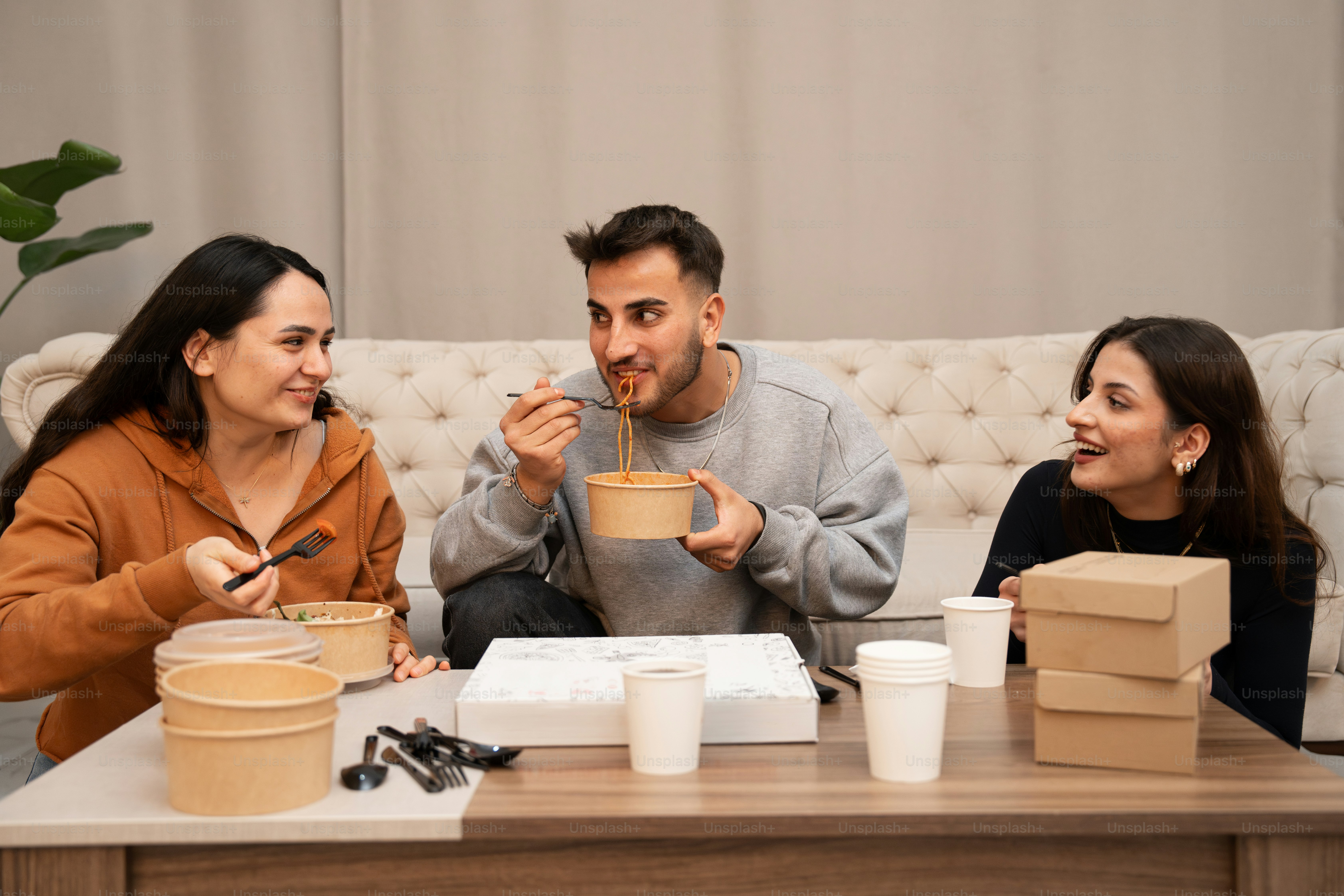 Group sharing takeout food on a table