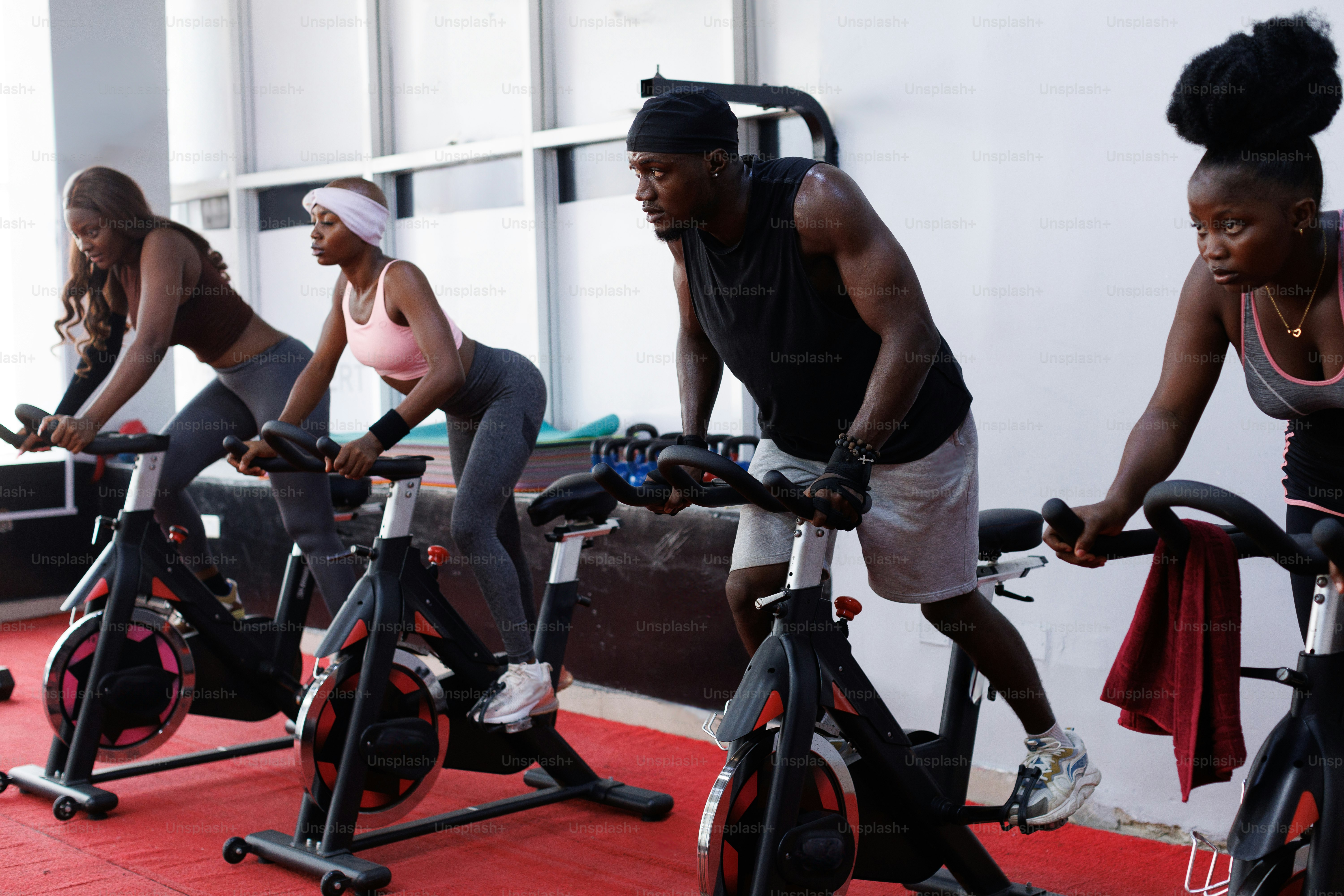 A group of people riding stationary bikes in a gym