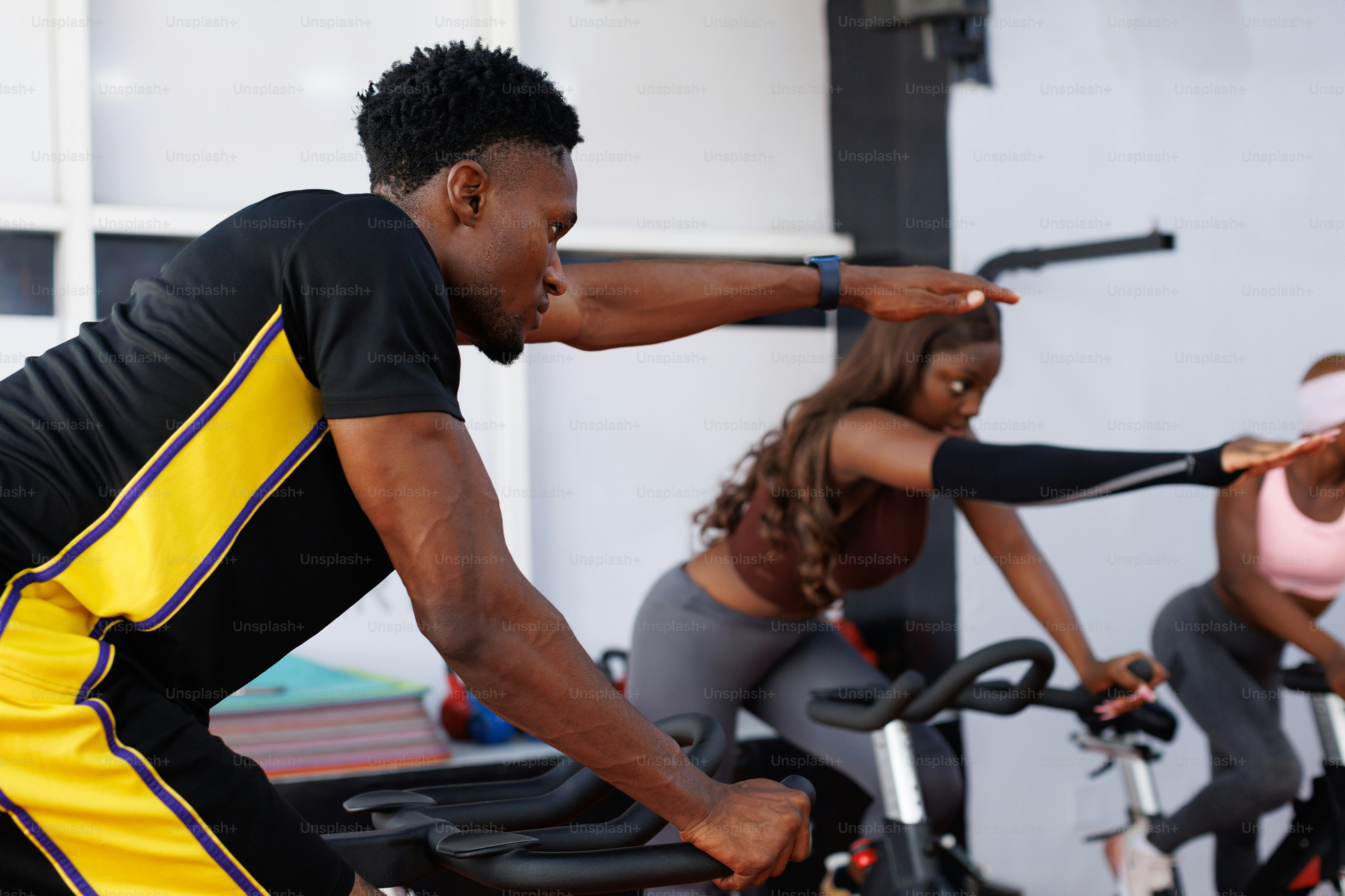 A group of people on exercise bikes in a gym