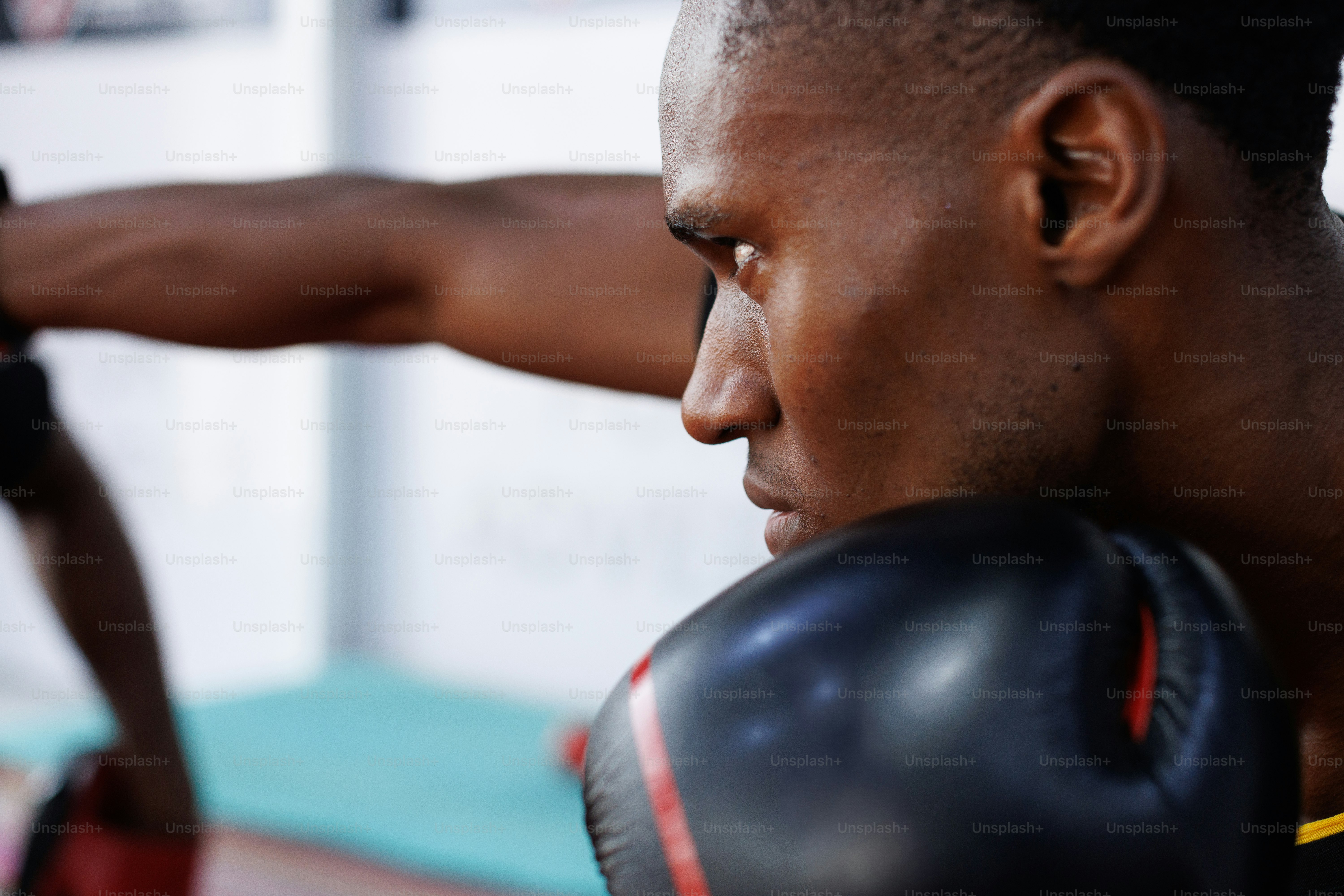 A man wearing a black shirt and boxing gloves