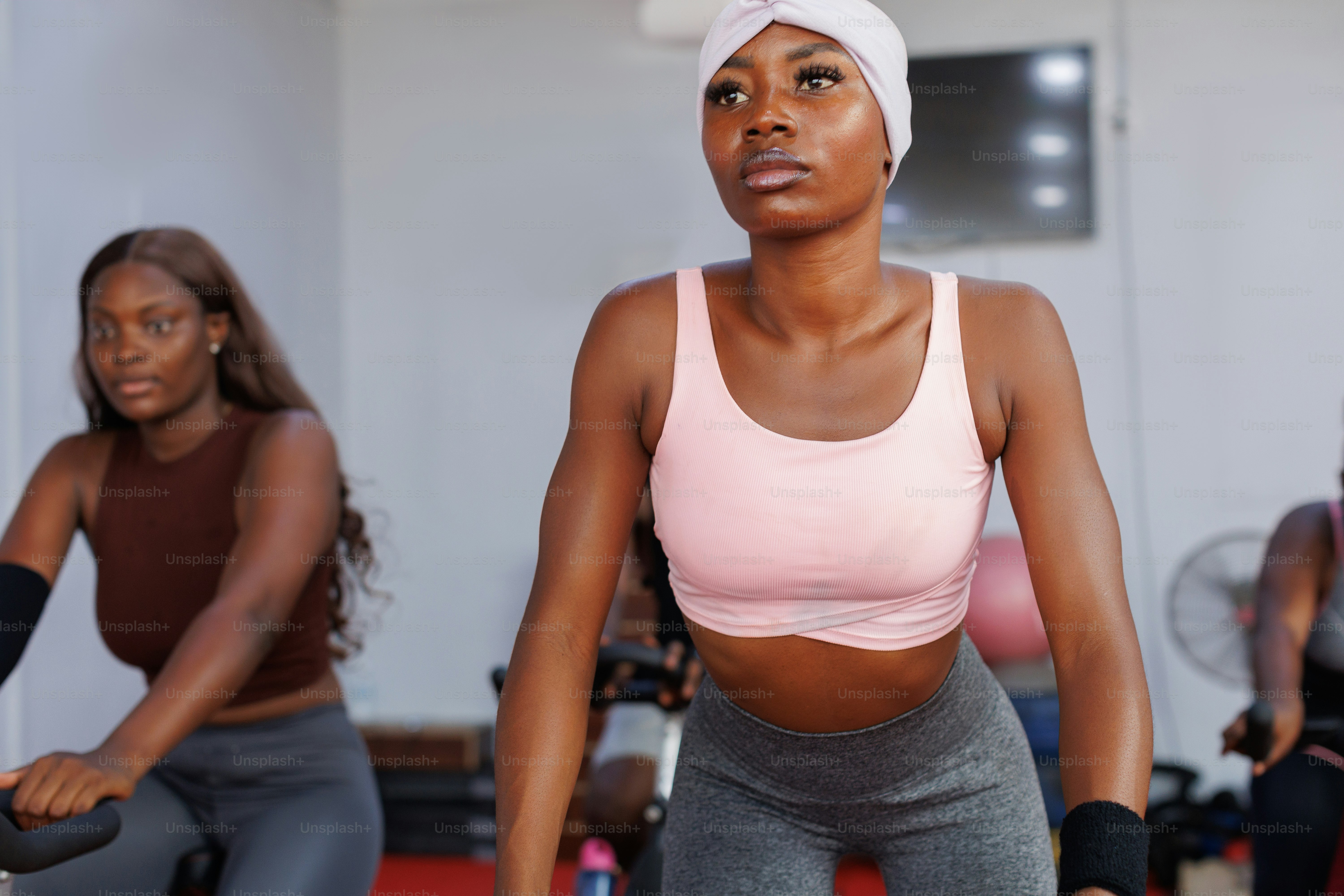 A group of women riding stationary exercise bikes