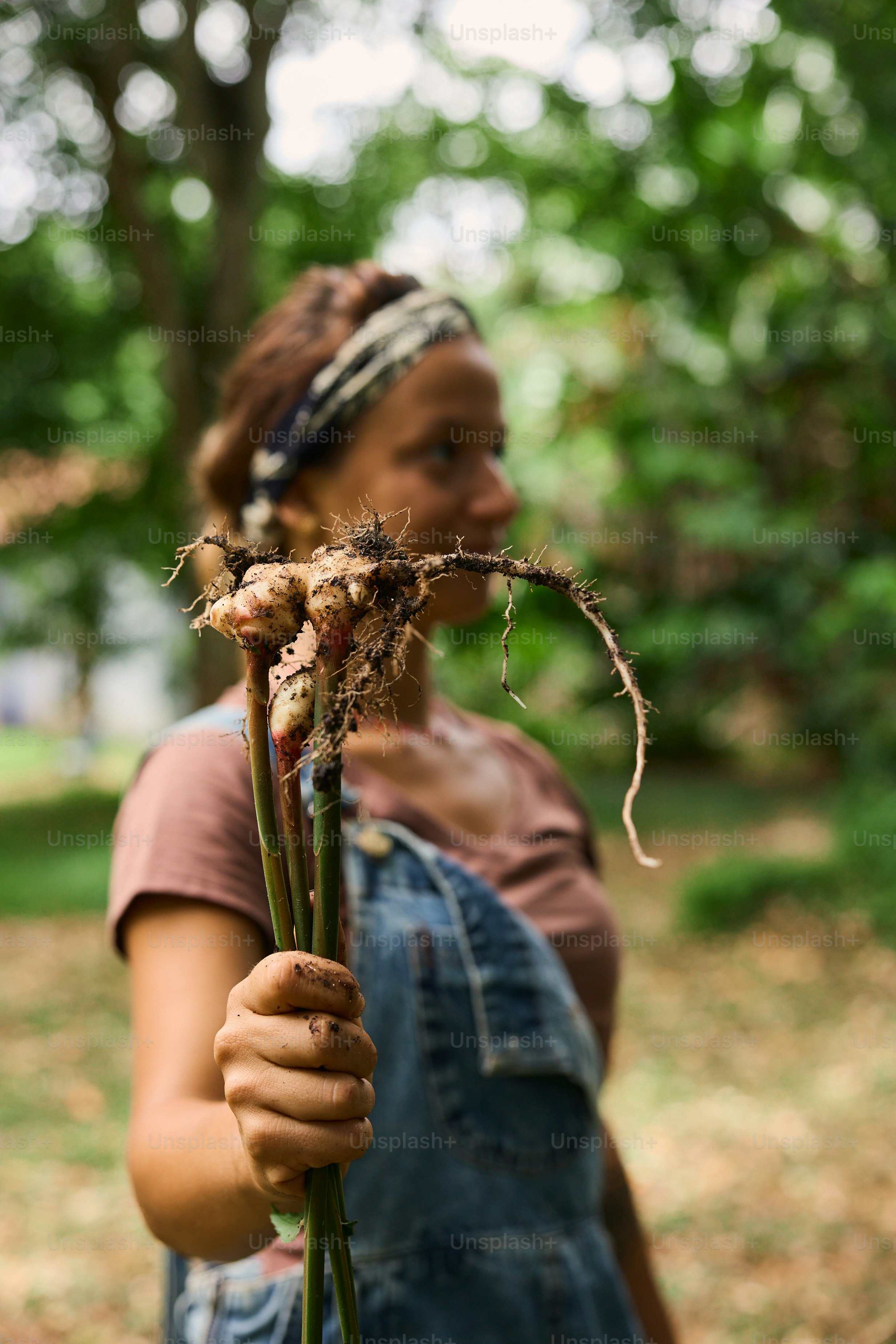 A woman holding a bunch of dead flowers