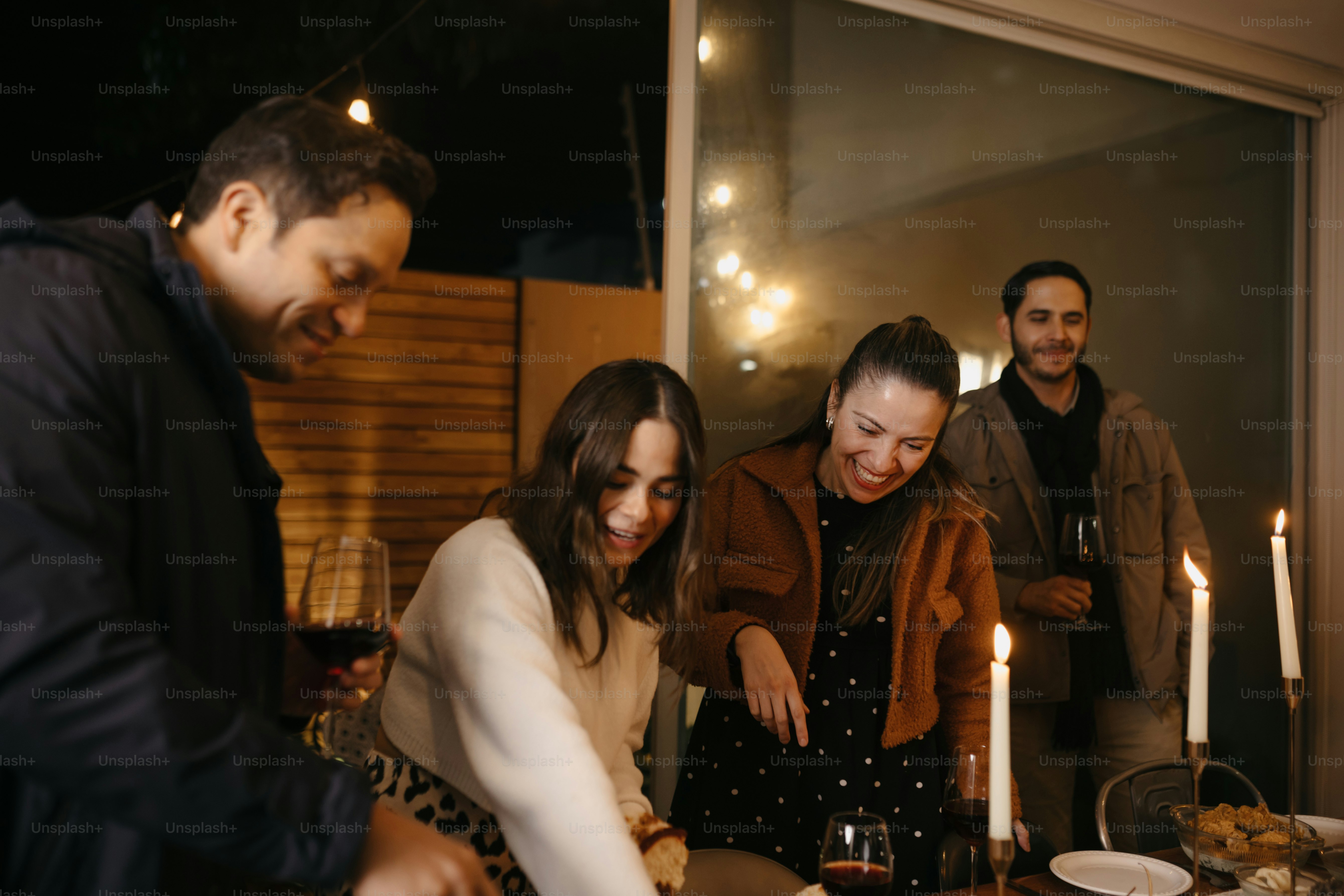 A group of people standing around a table with a cake photo – Family ...
