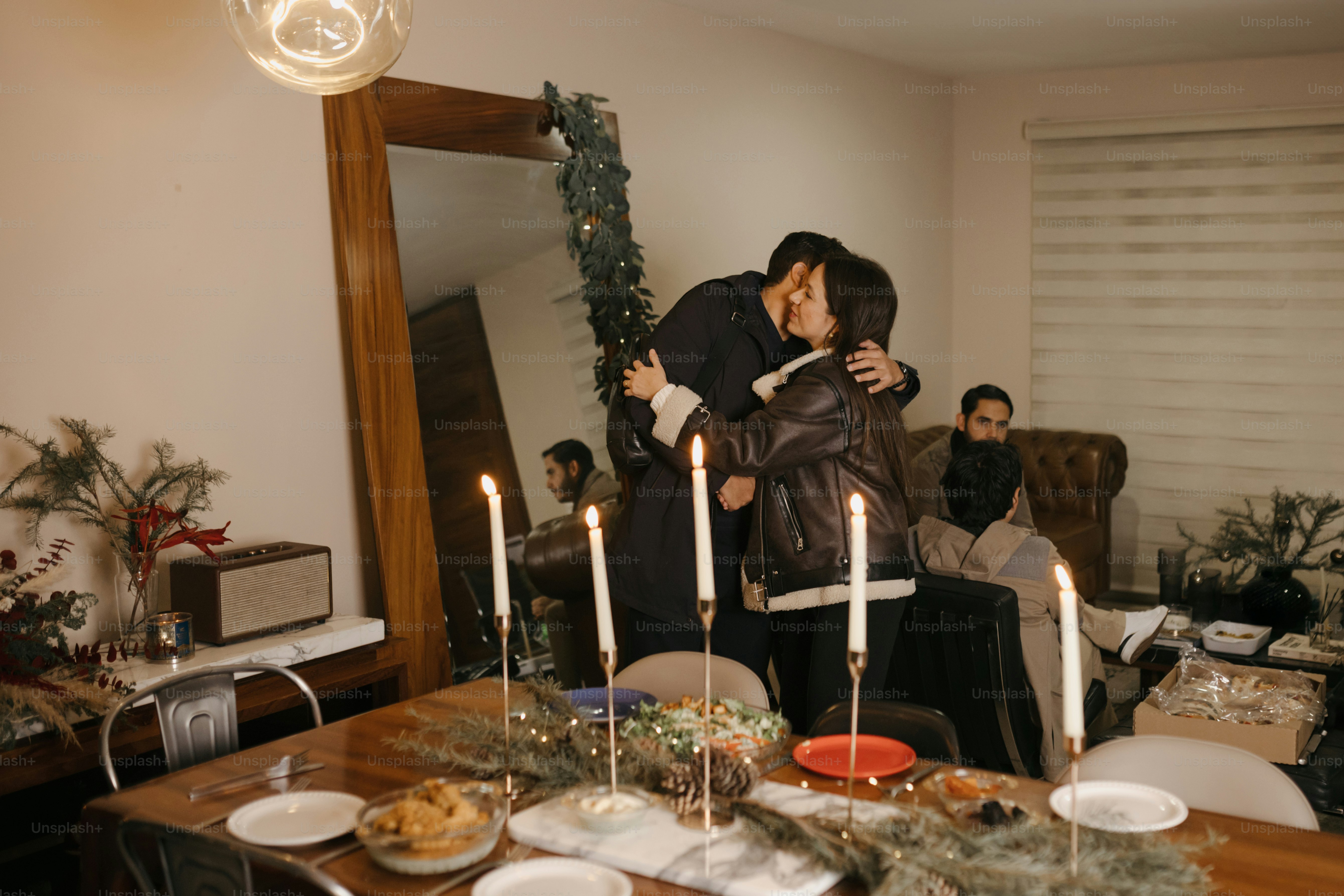 A couple embracing each other in front of a dining room table