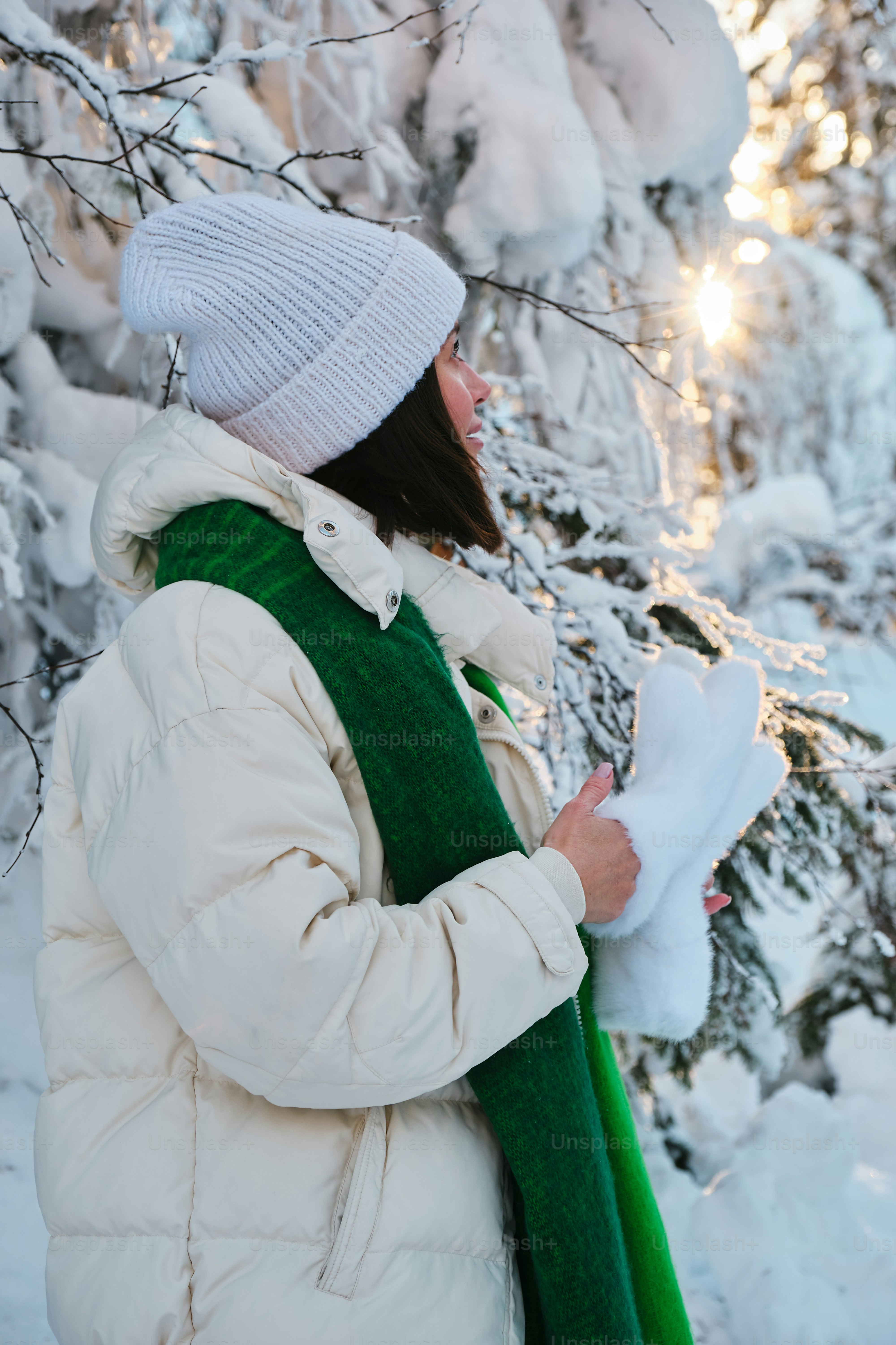 A woman standing in front of a snow covered tree