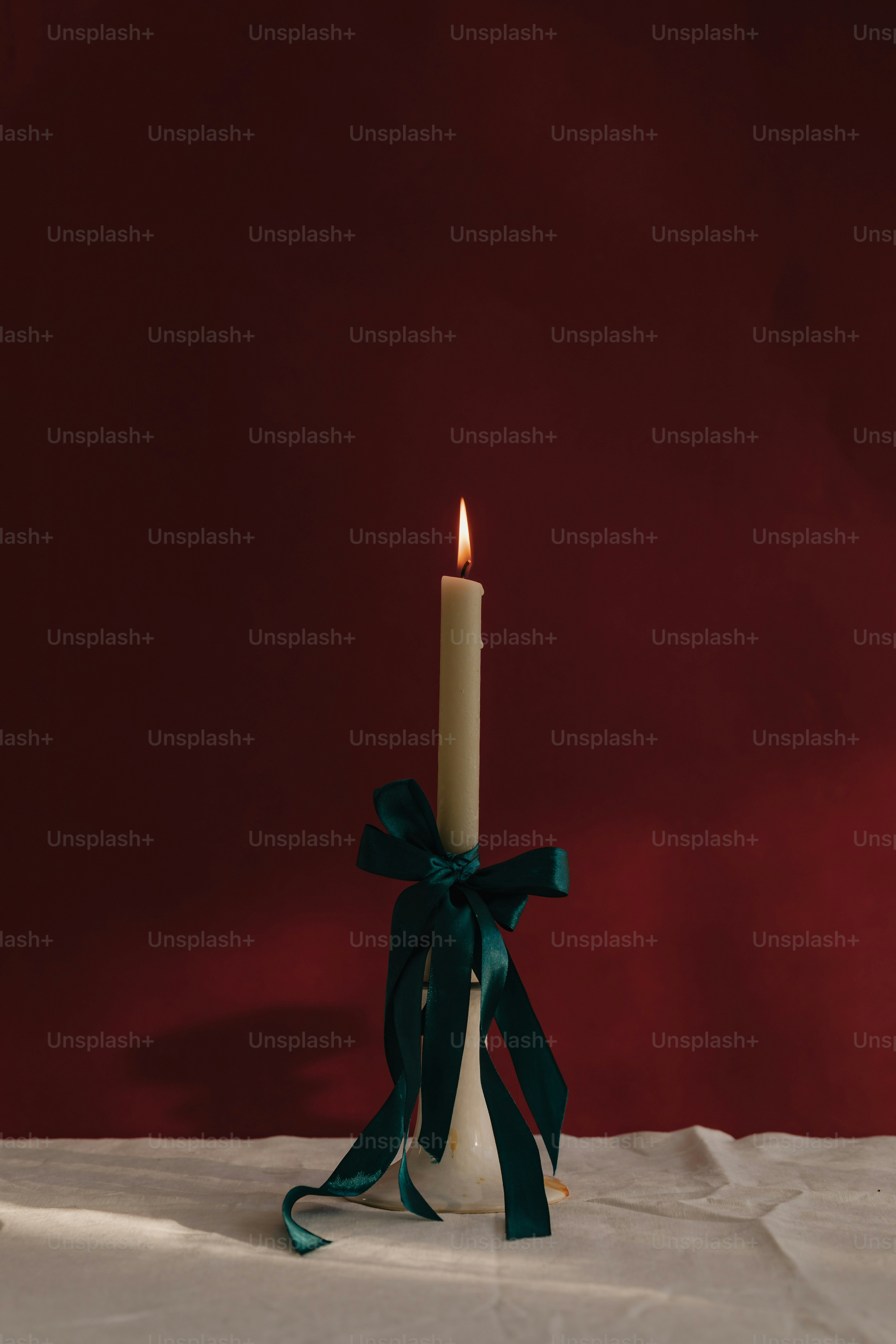 Una candela accesa con un nastro verde intorno