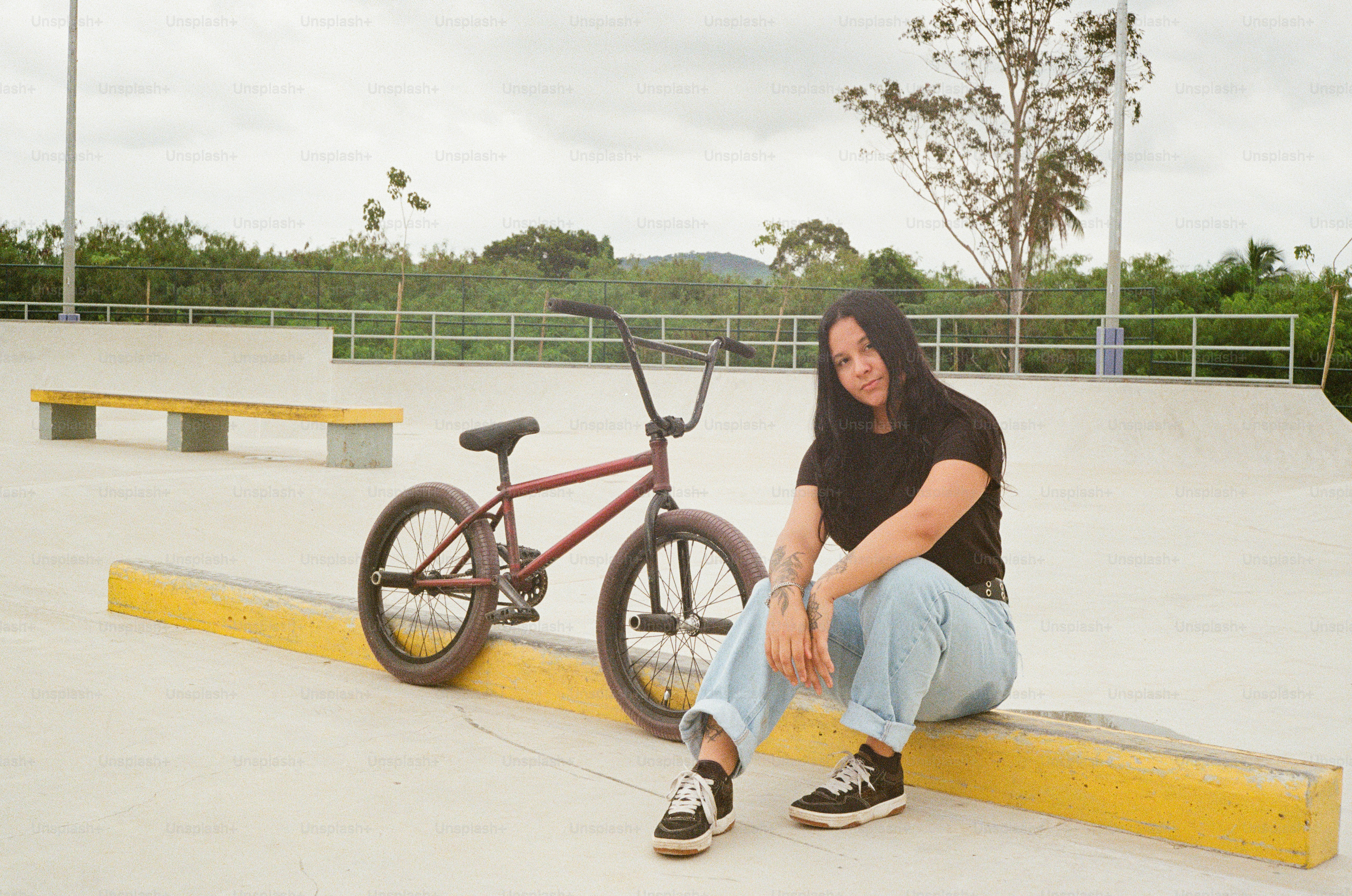 A man sitting on a bench next to a bike