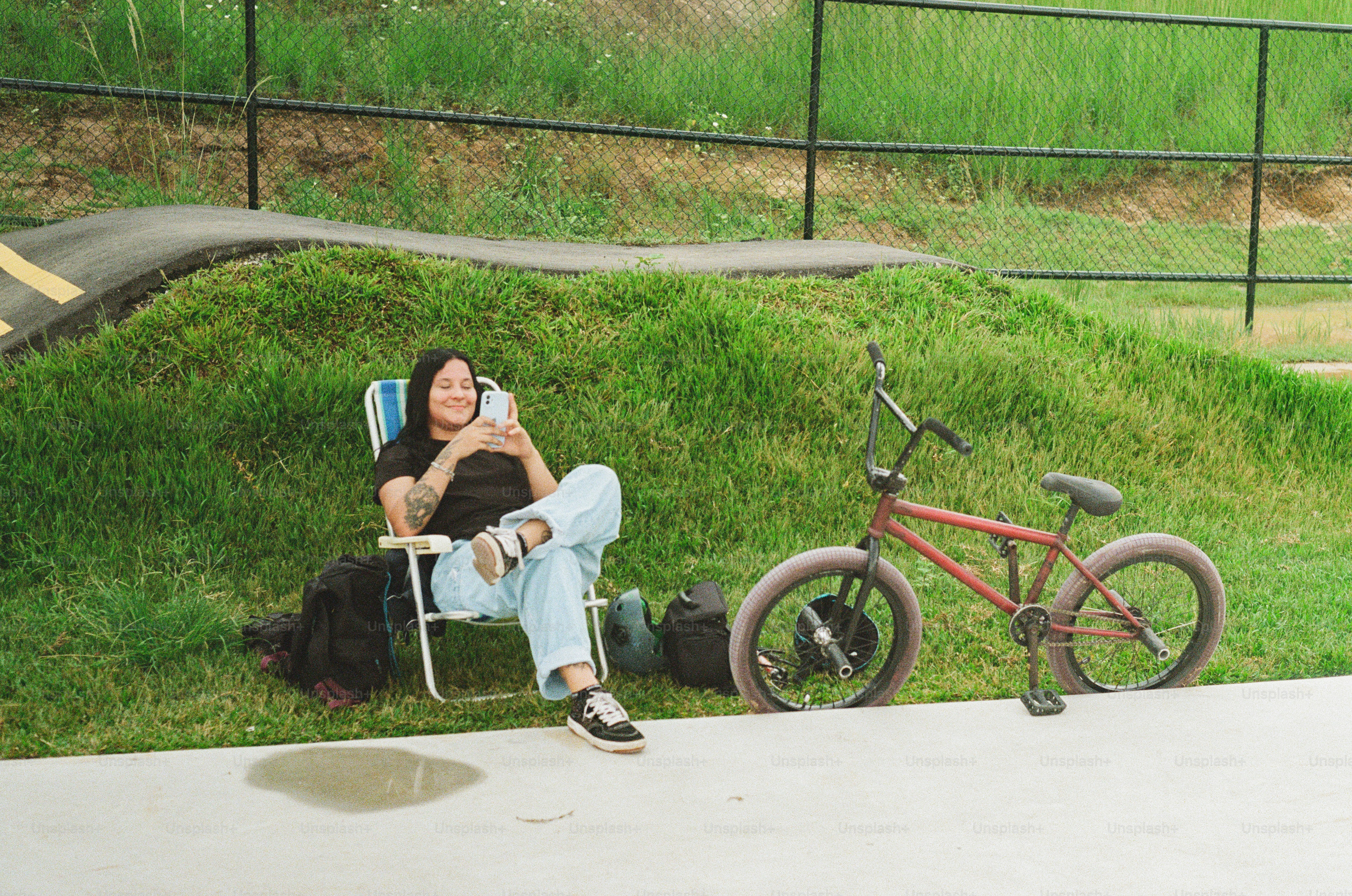 A woman sitting in a chair next to a bike