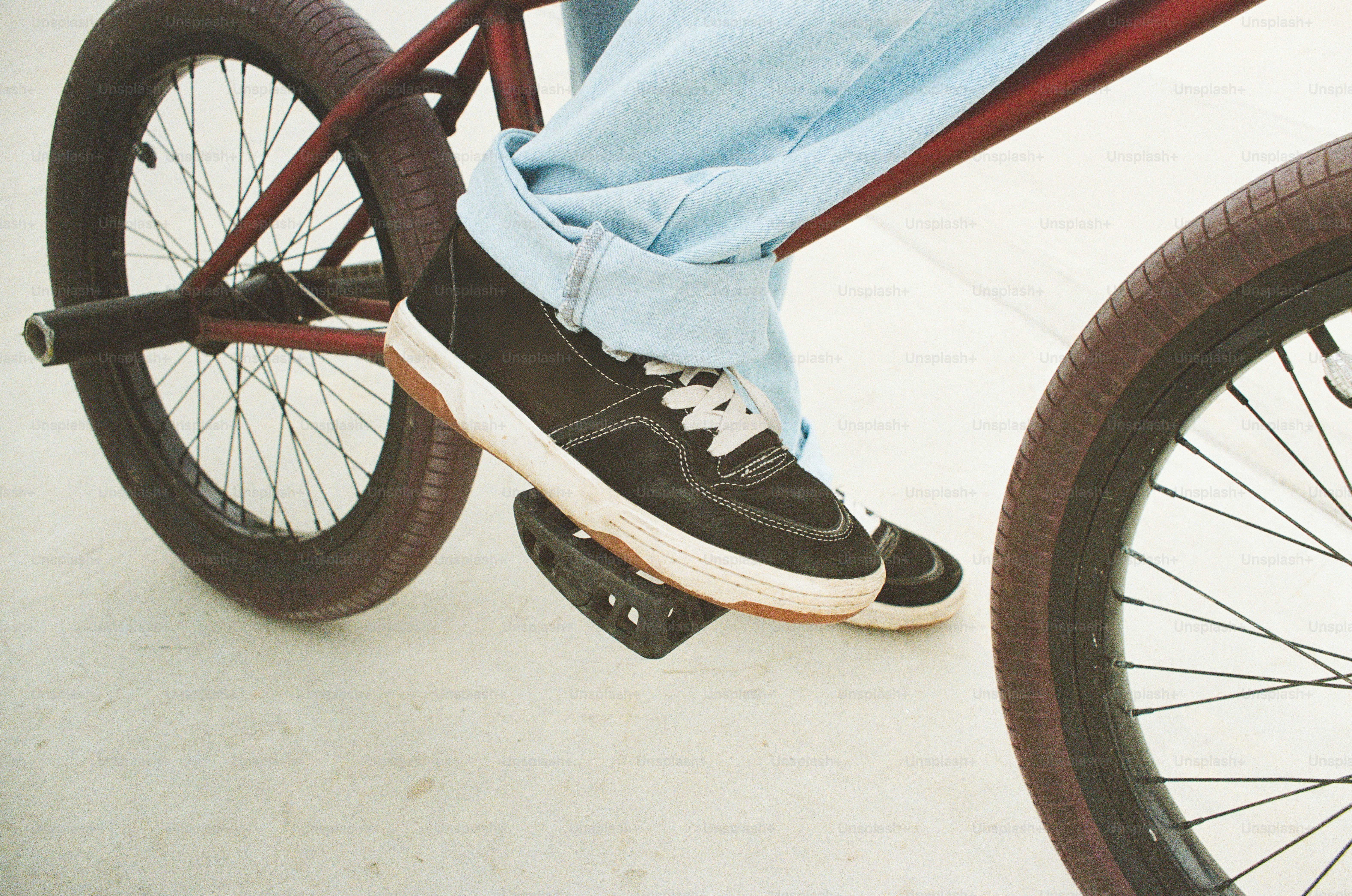 A person riding a bike on a sidewalk