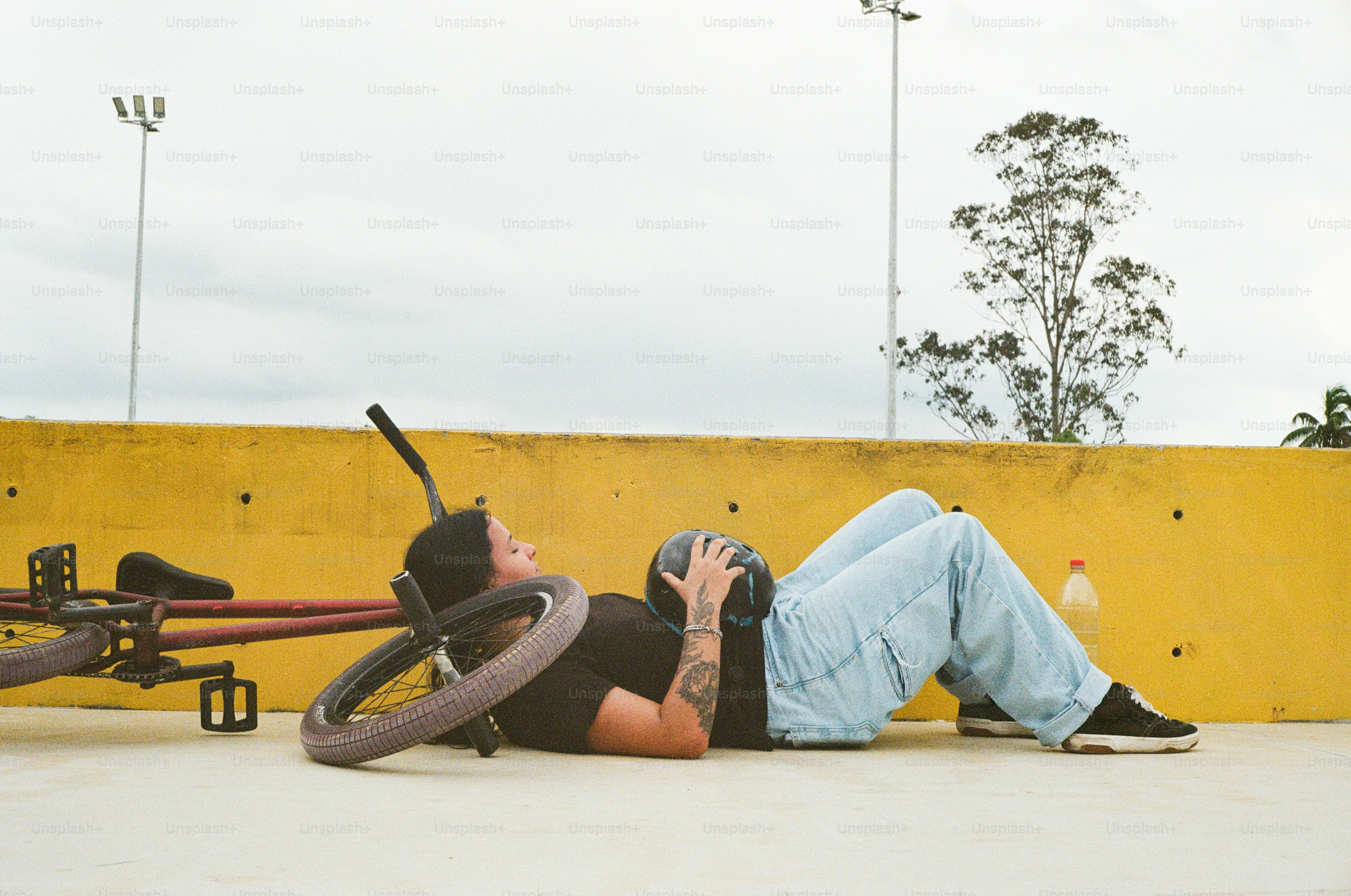 A man laying on the ground with a baseball bat