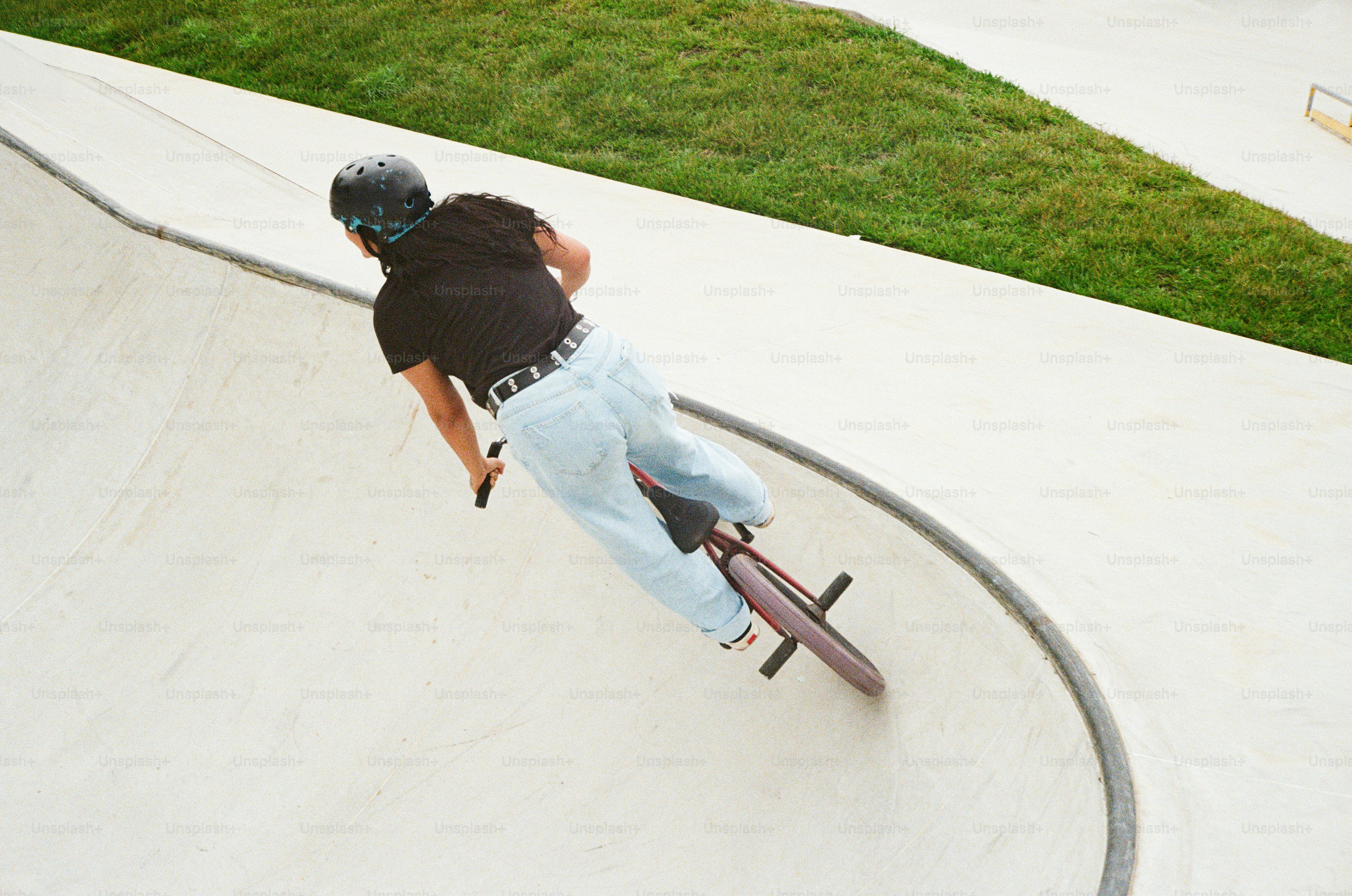 A man riding a skateboard up the side of a ramp