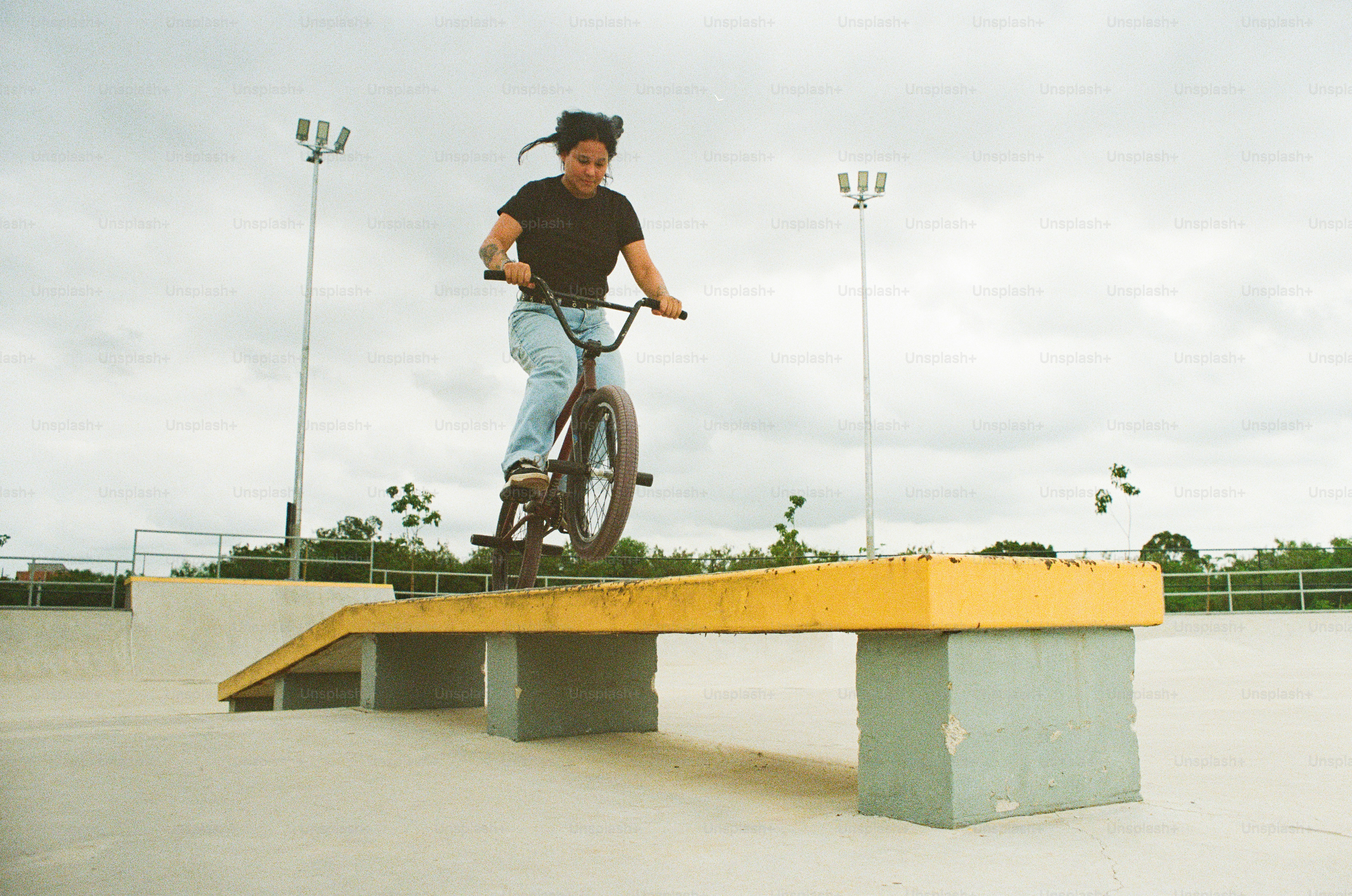 A man riding a bike on top of a wooden bench
