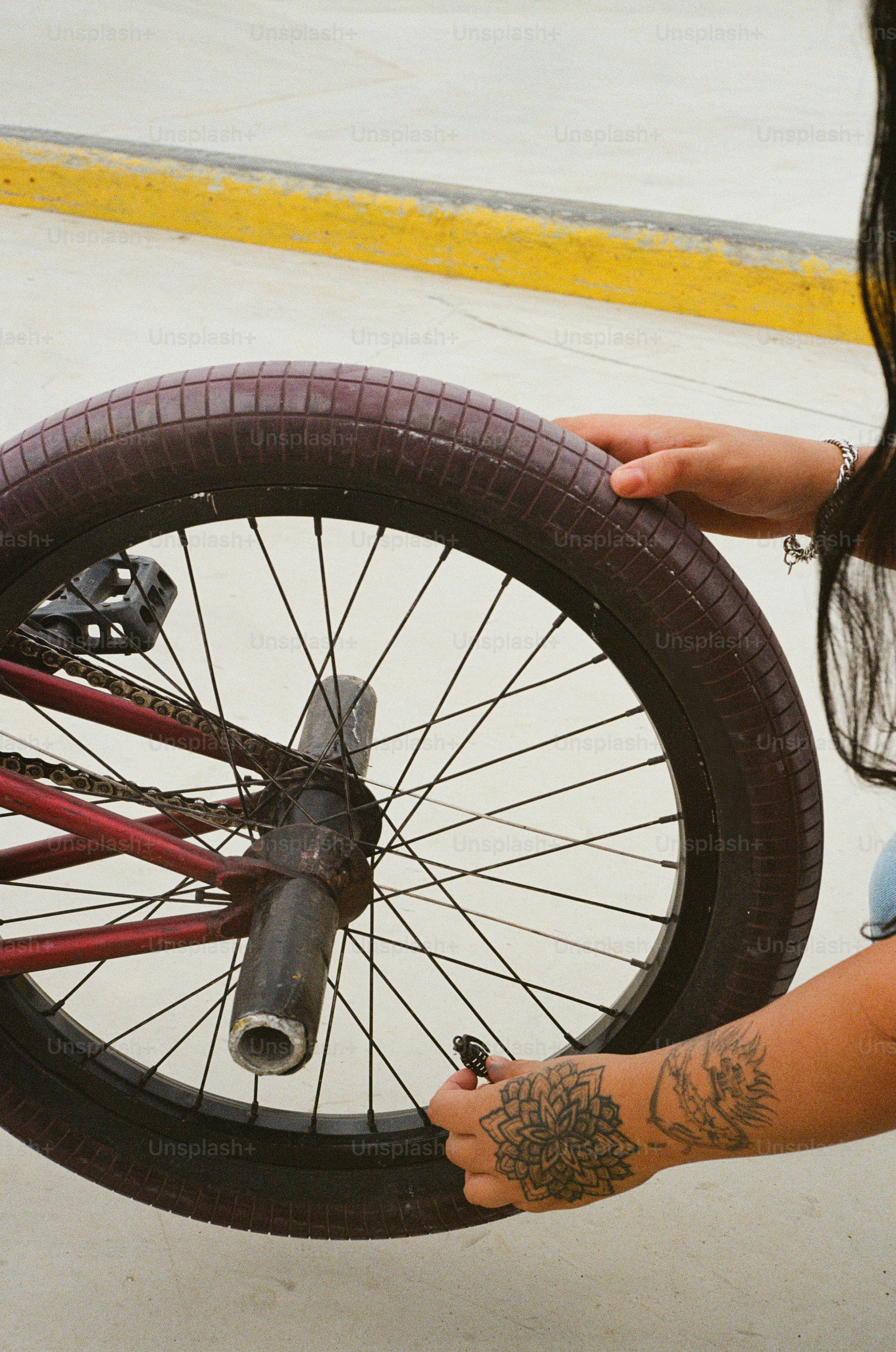 A woman is holding a bicycle tire in her hand