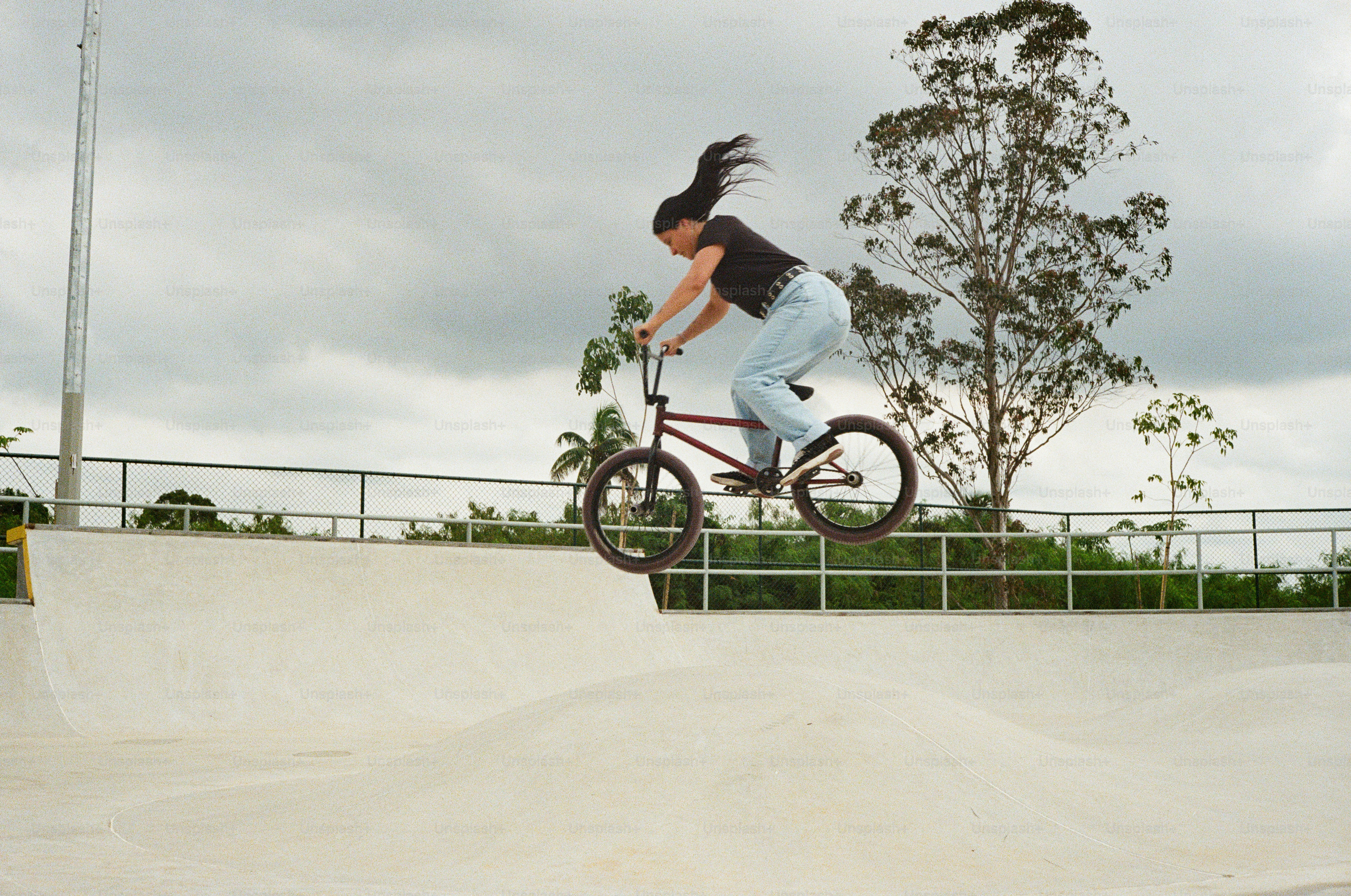 A person riding a bike at a skate park