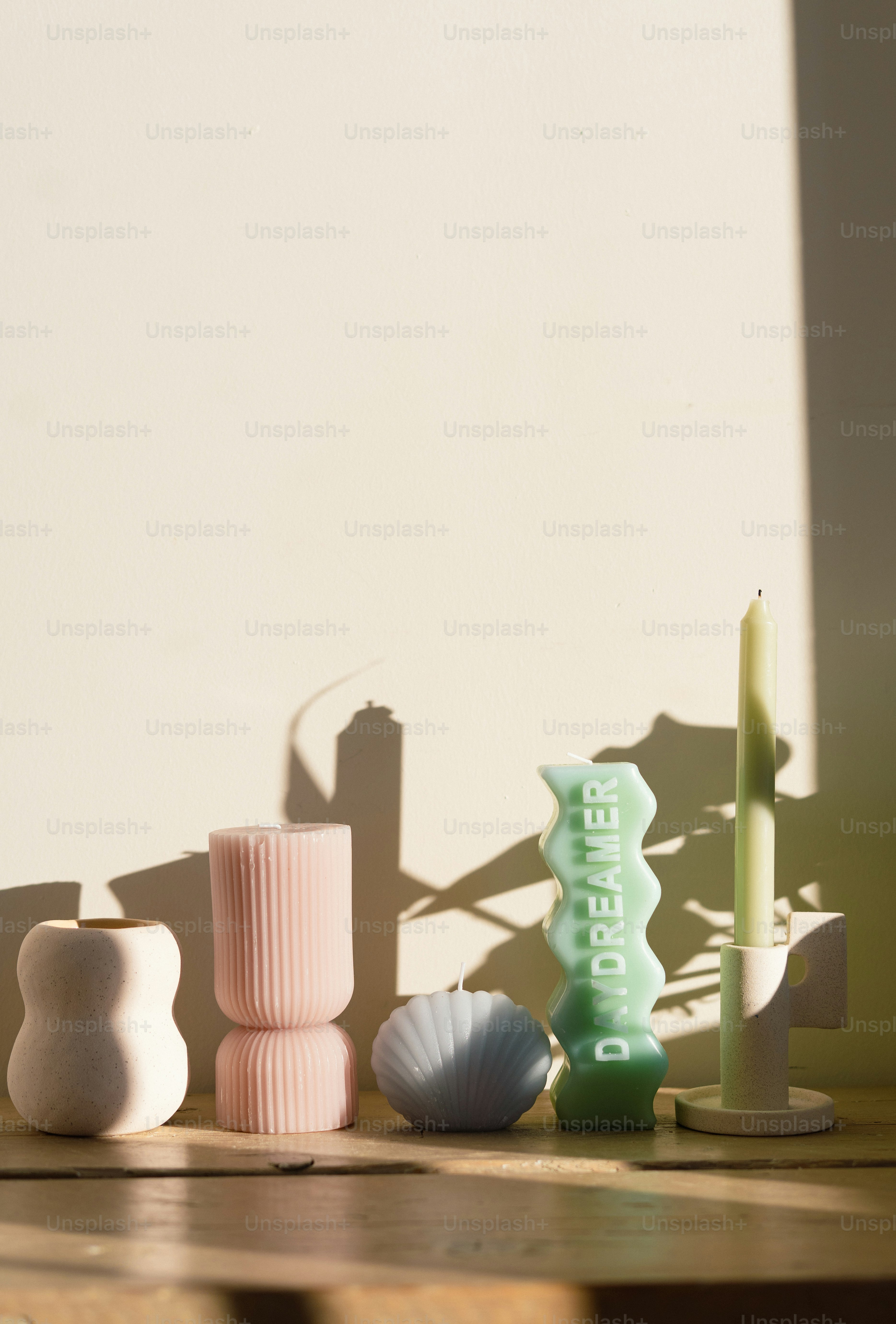 A wooden table topped with vases and candles