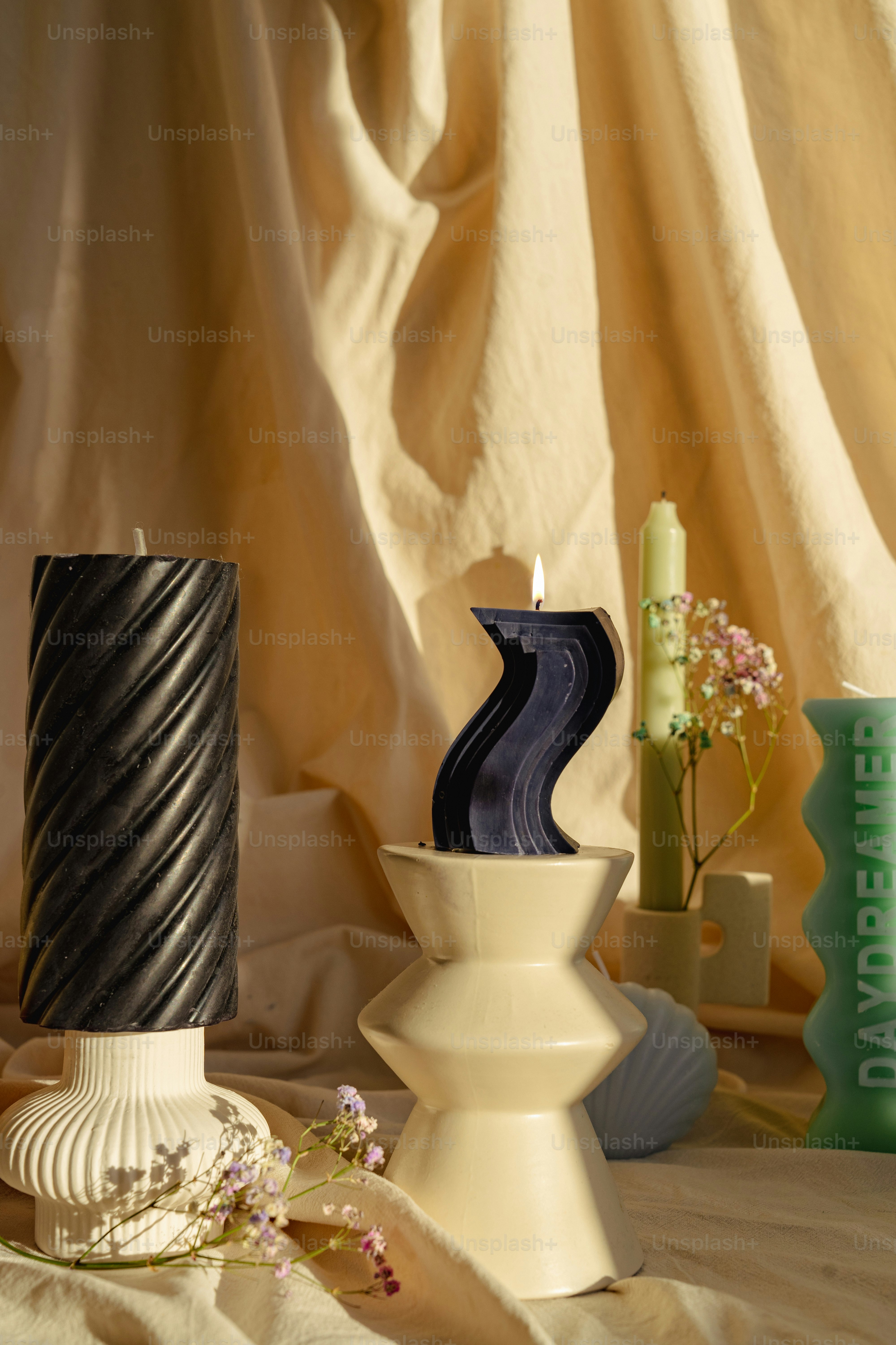 A table topped with vases and candles on top of a table