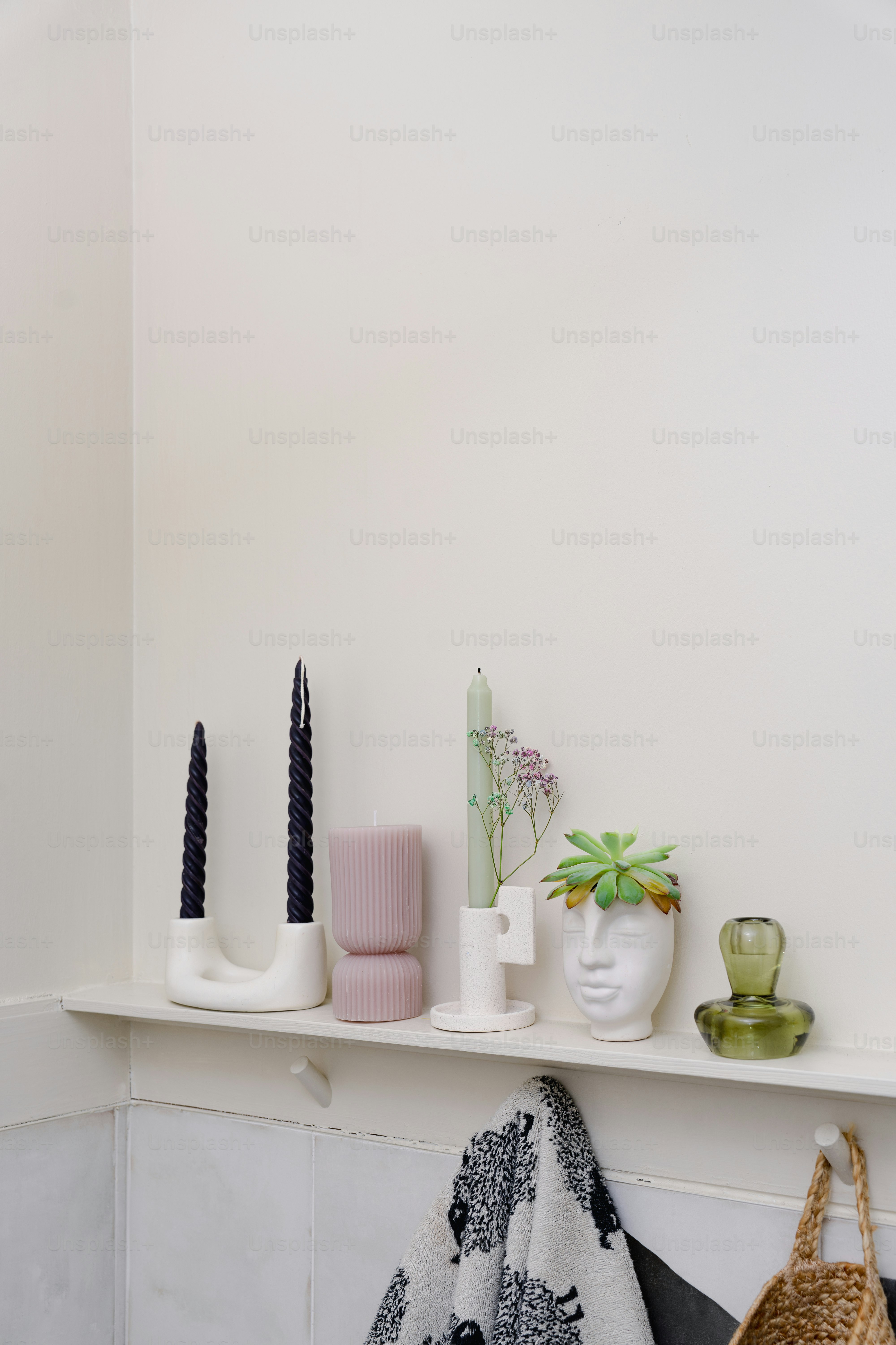 A shelf with a basket, vases, and other items on it