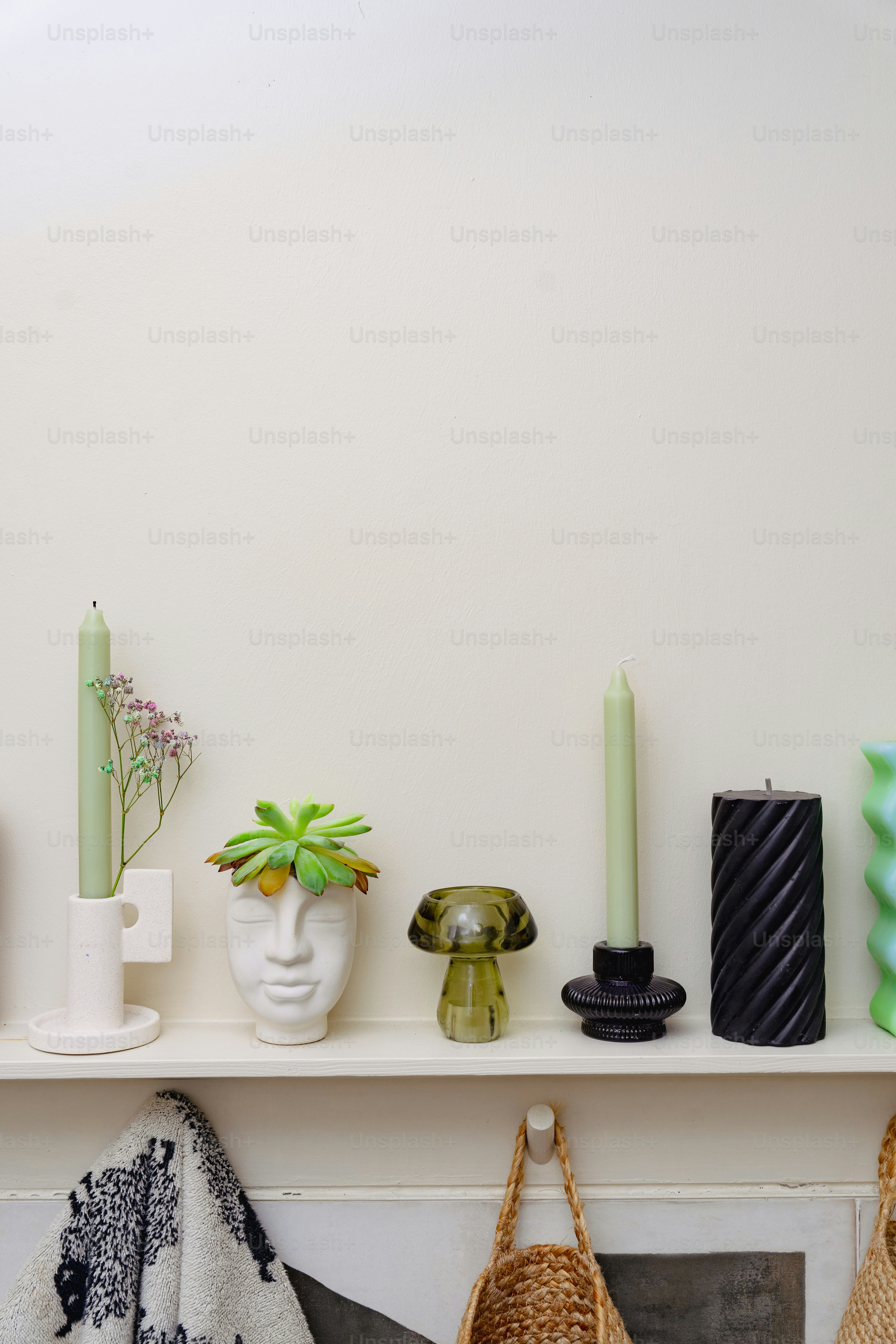 A shelf with vases, candles, and other items on it