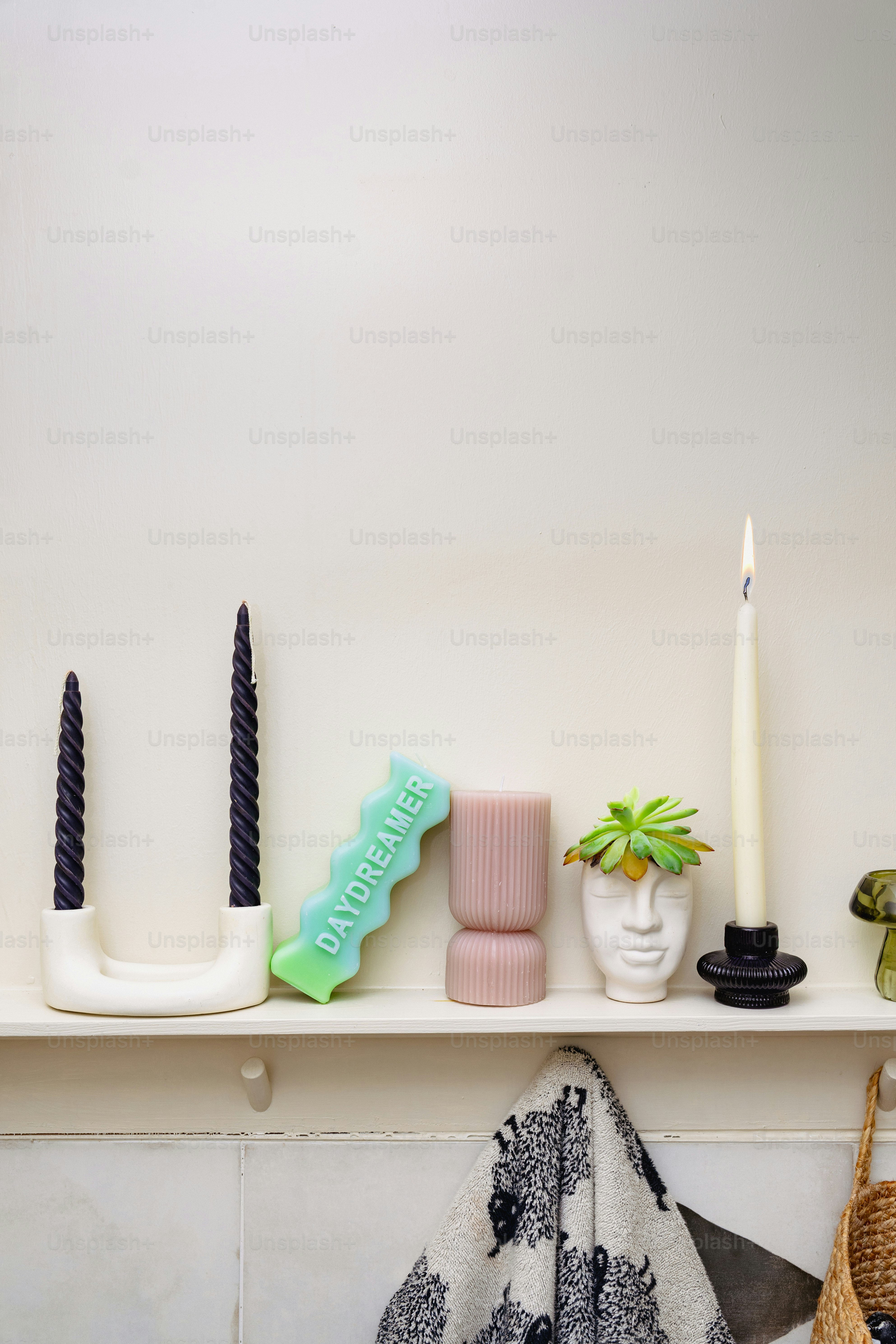 A shelf with candles, vases, and other items on it