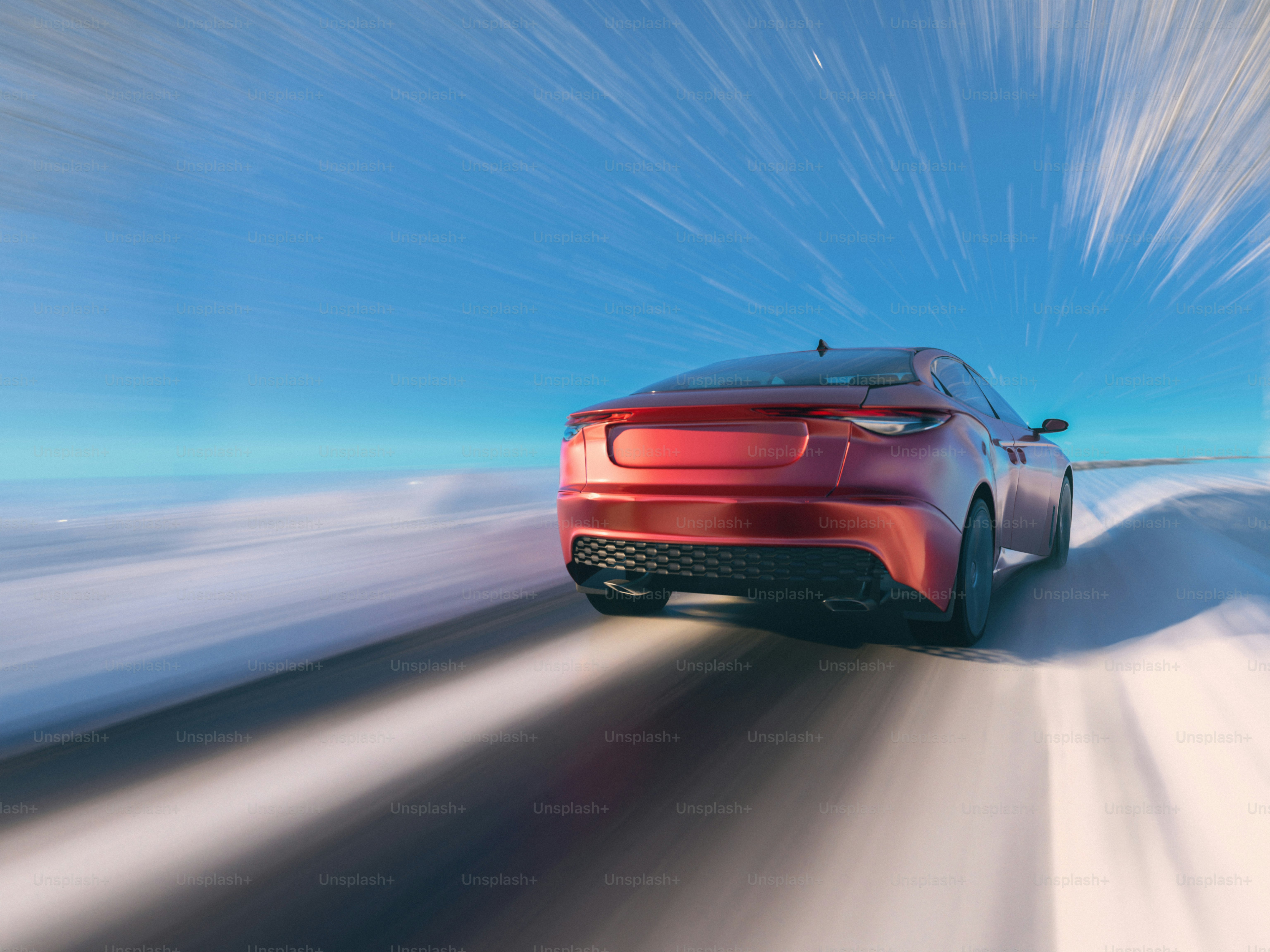 A red sports car driving on a snowy road