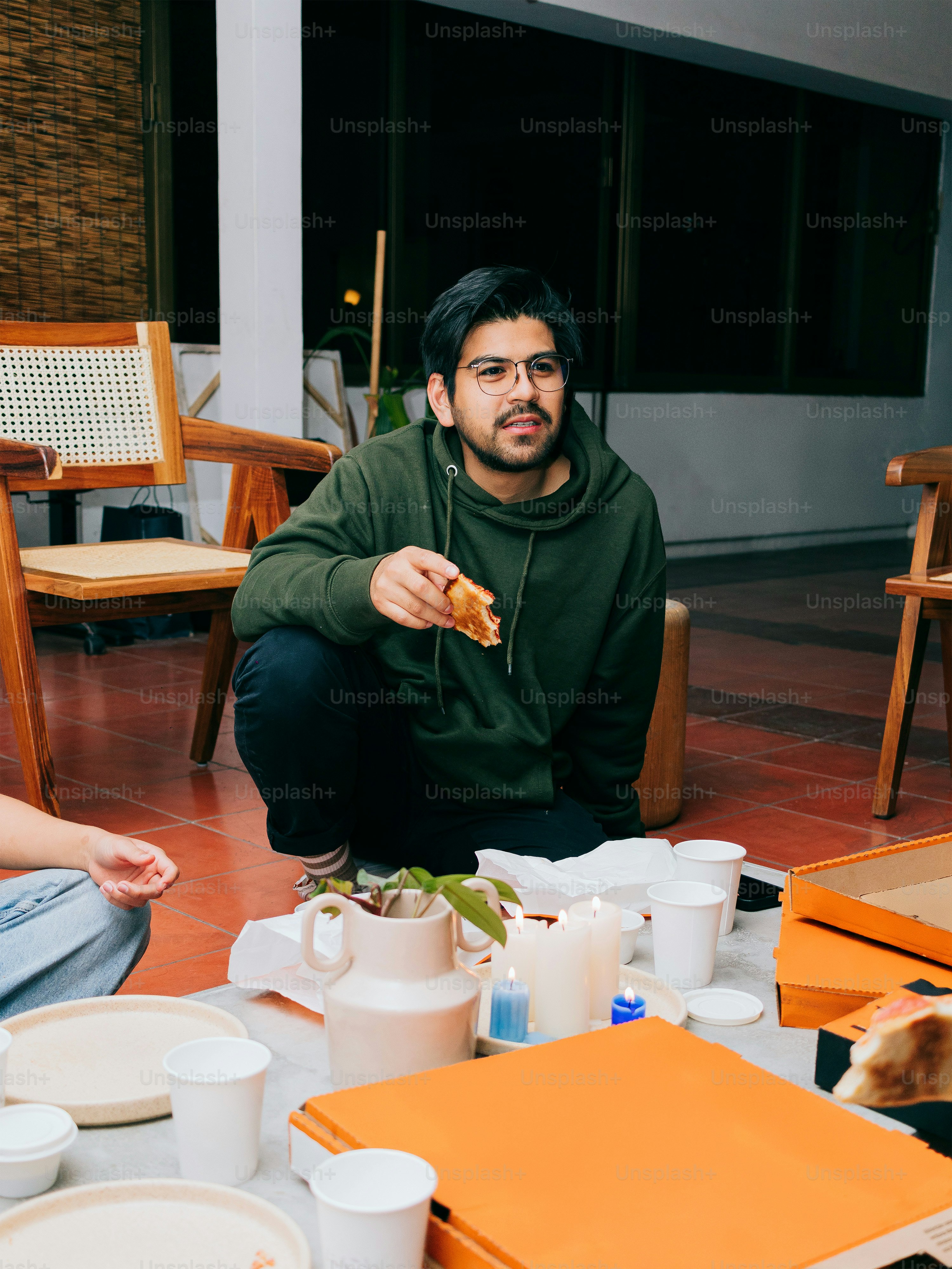 A group of men sitting around a table looking at a book photo – Fast ...