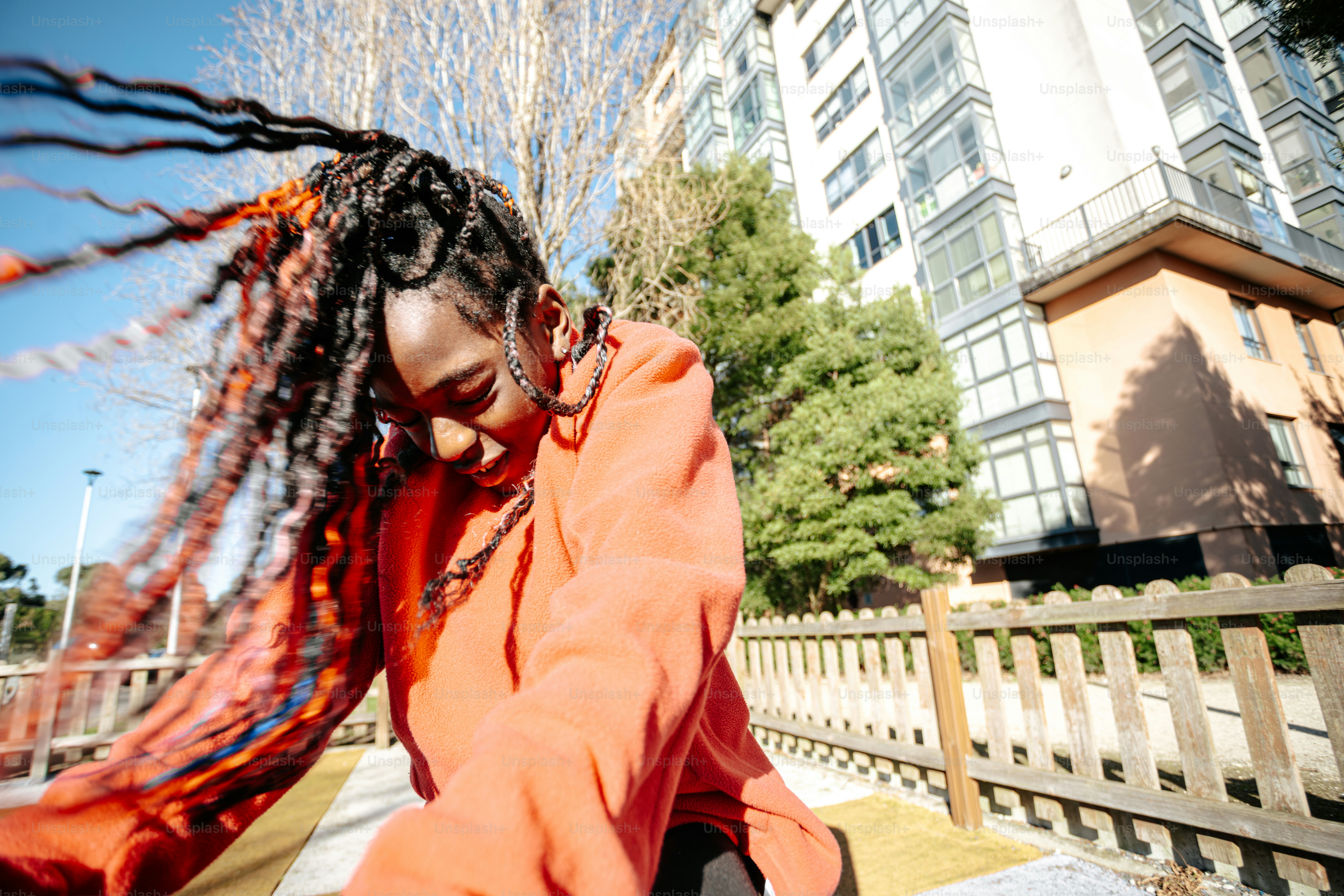A woman with dreadlocks walking down a street